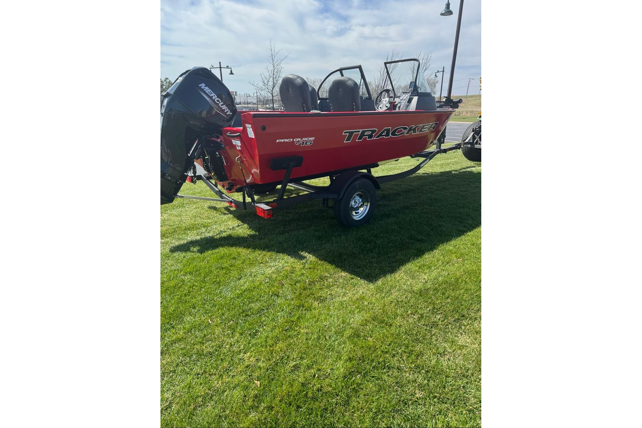 2026 Tracker Pro Guide V-16 WT boat on grass, featuring a Mercury outboard motor.