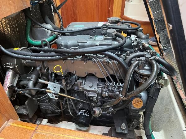 Engine compartment of a 2000 Hunter 410 with visible hoses and cables.