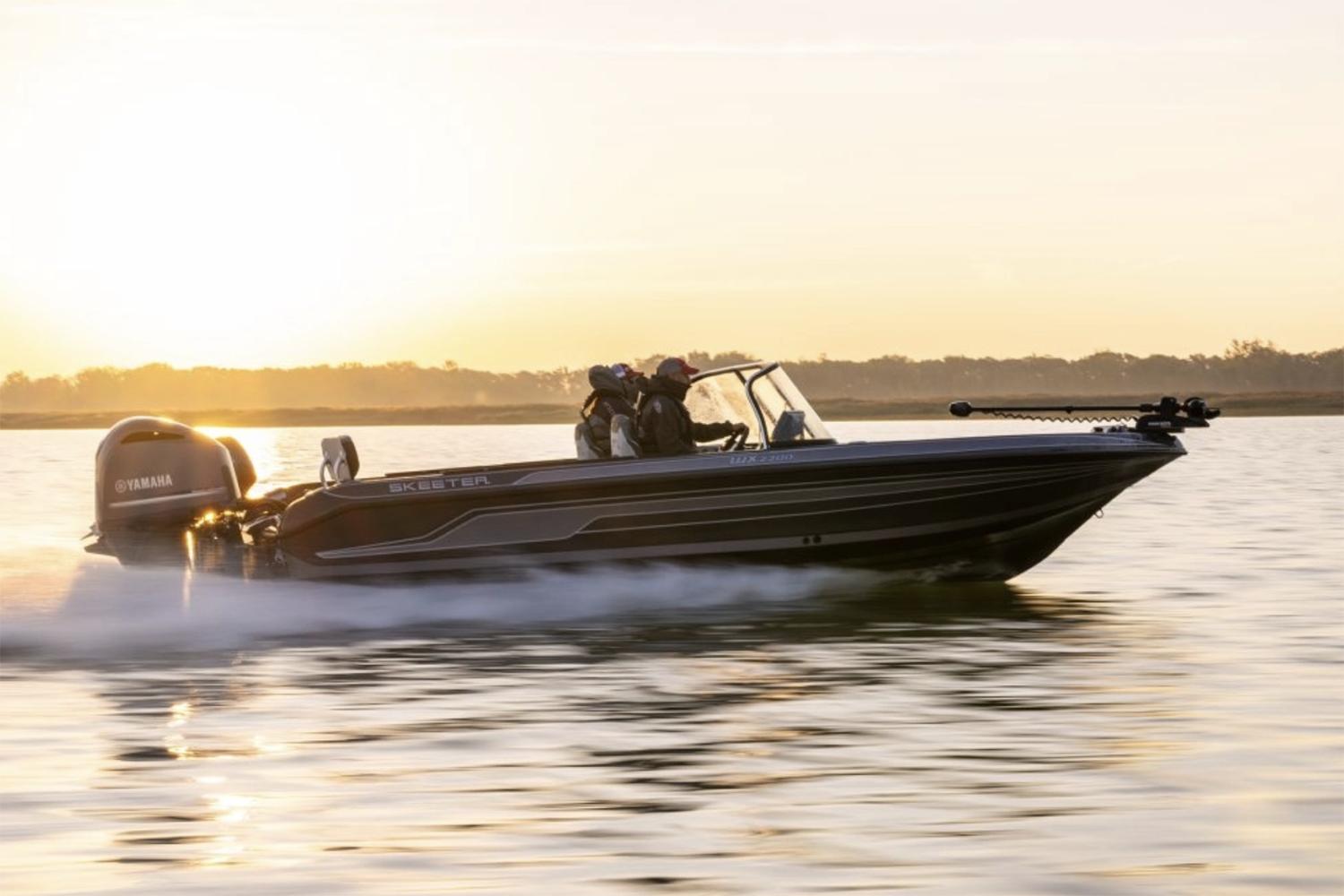 Manufacturer Provided Image: 2025 Skeeter WX2200 boat cruising on a lake at sunset.