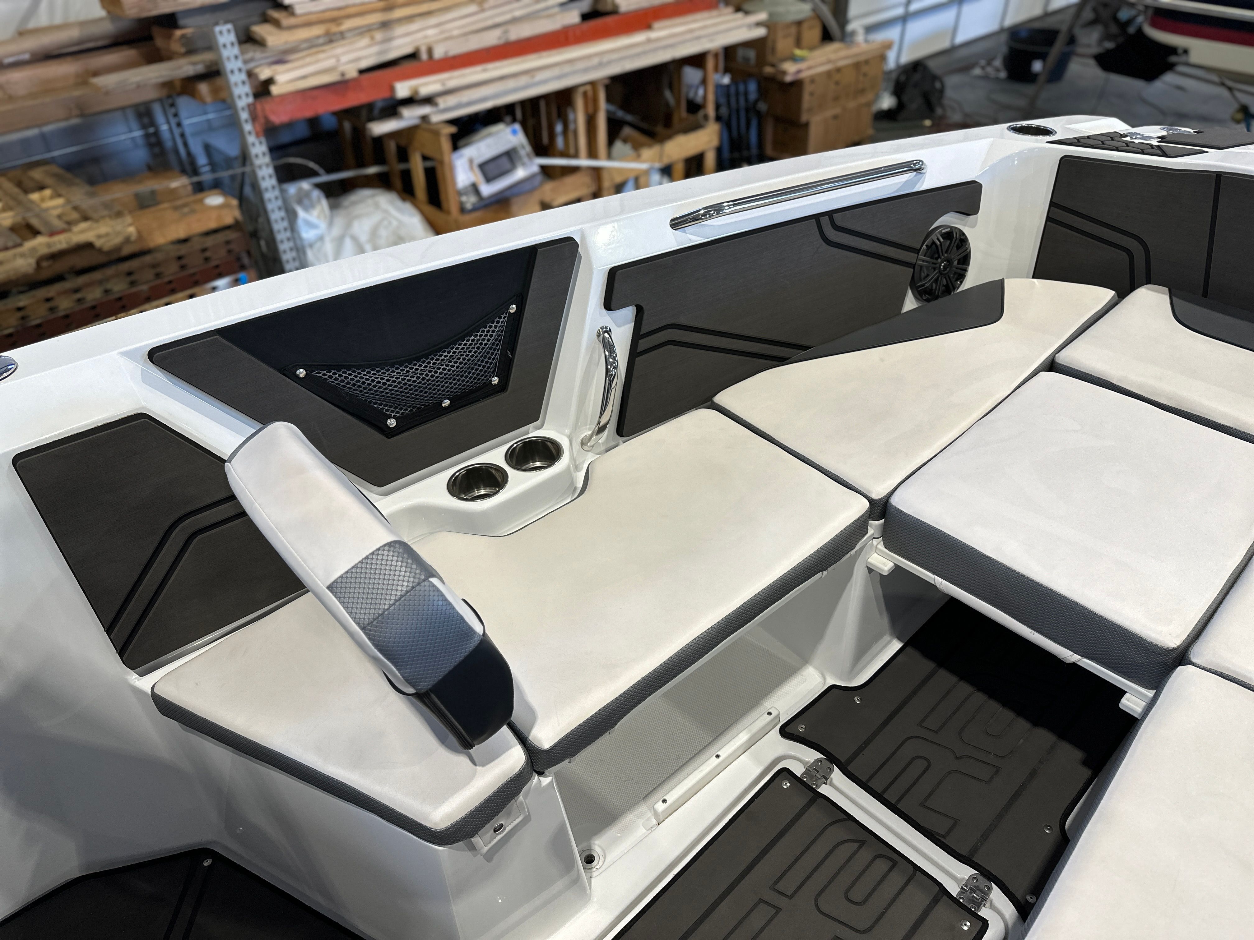The image shows the interior of a 2021 Scarab 255 Open ID boat with white and gray seating.