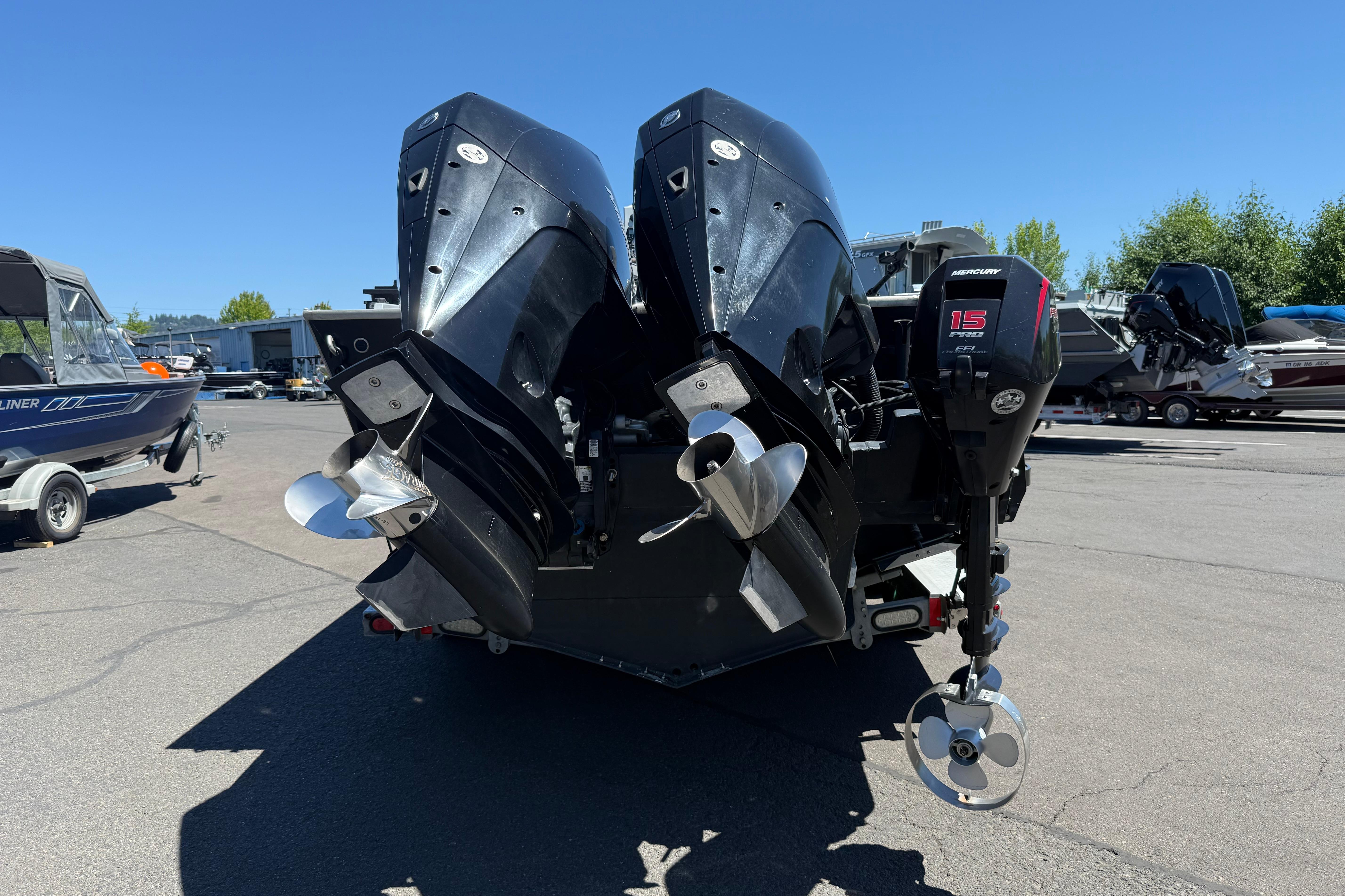 2015 Alumaweld Pacific XD 28 boat with dual outboard motors in a marina setting.
