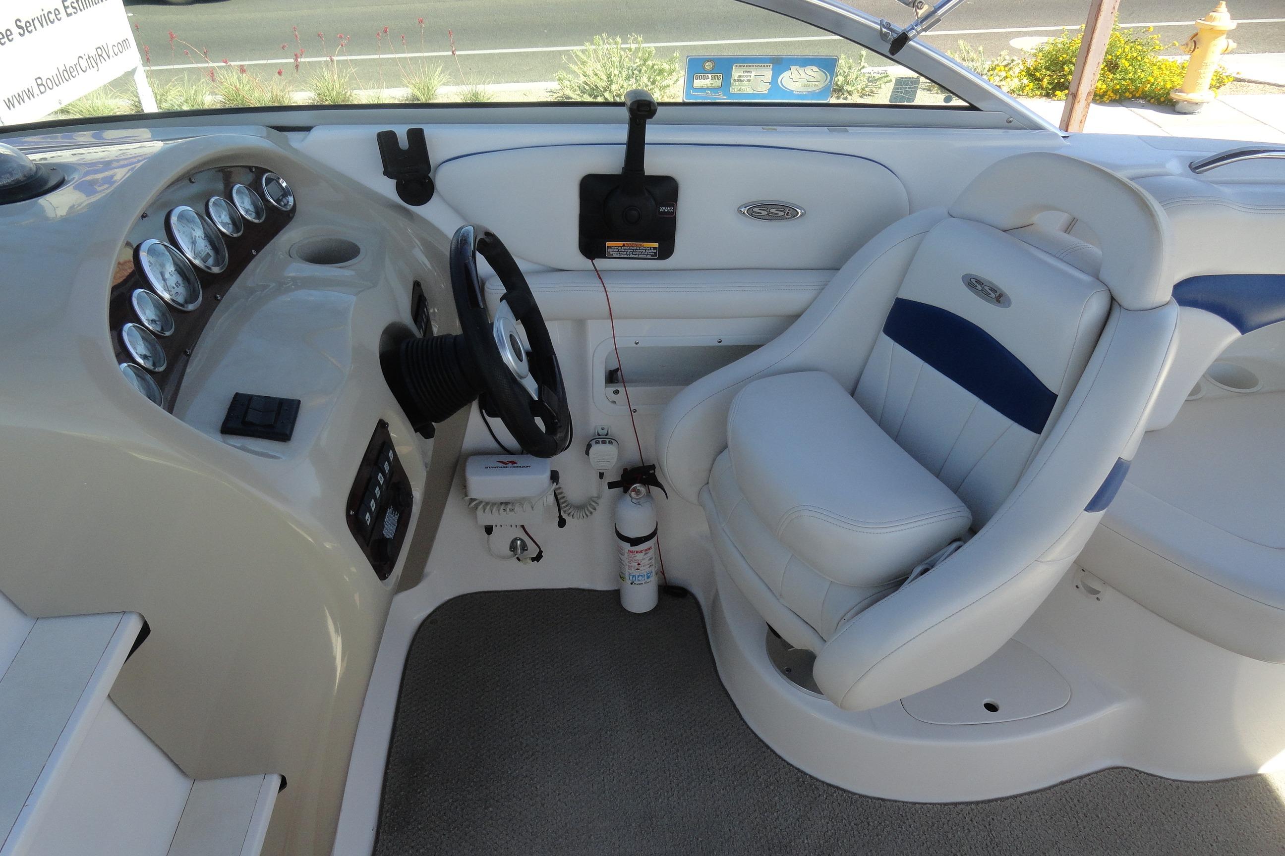 Interior cockpit of a 2001 Chaparral 265 SSi boat with steering wheel and gauges.