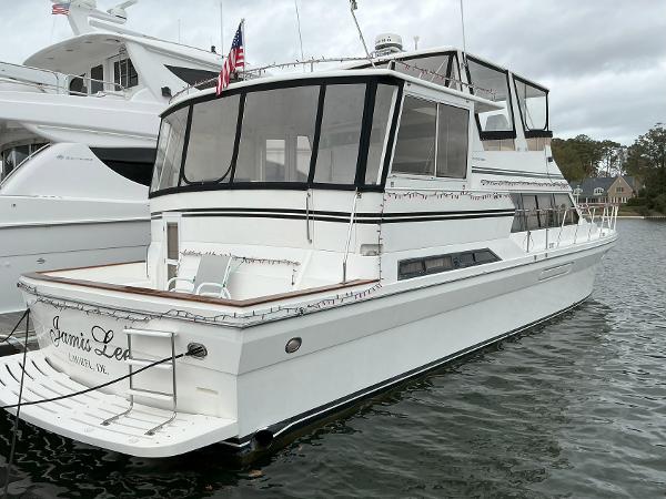 Novatec Islander 55 yacht, 2000 model, docked in a marina with American flag.