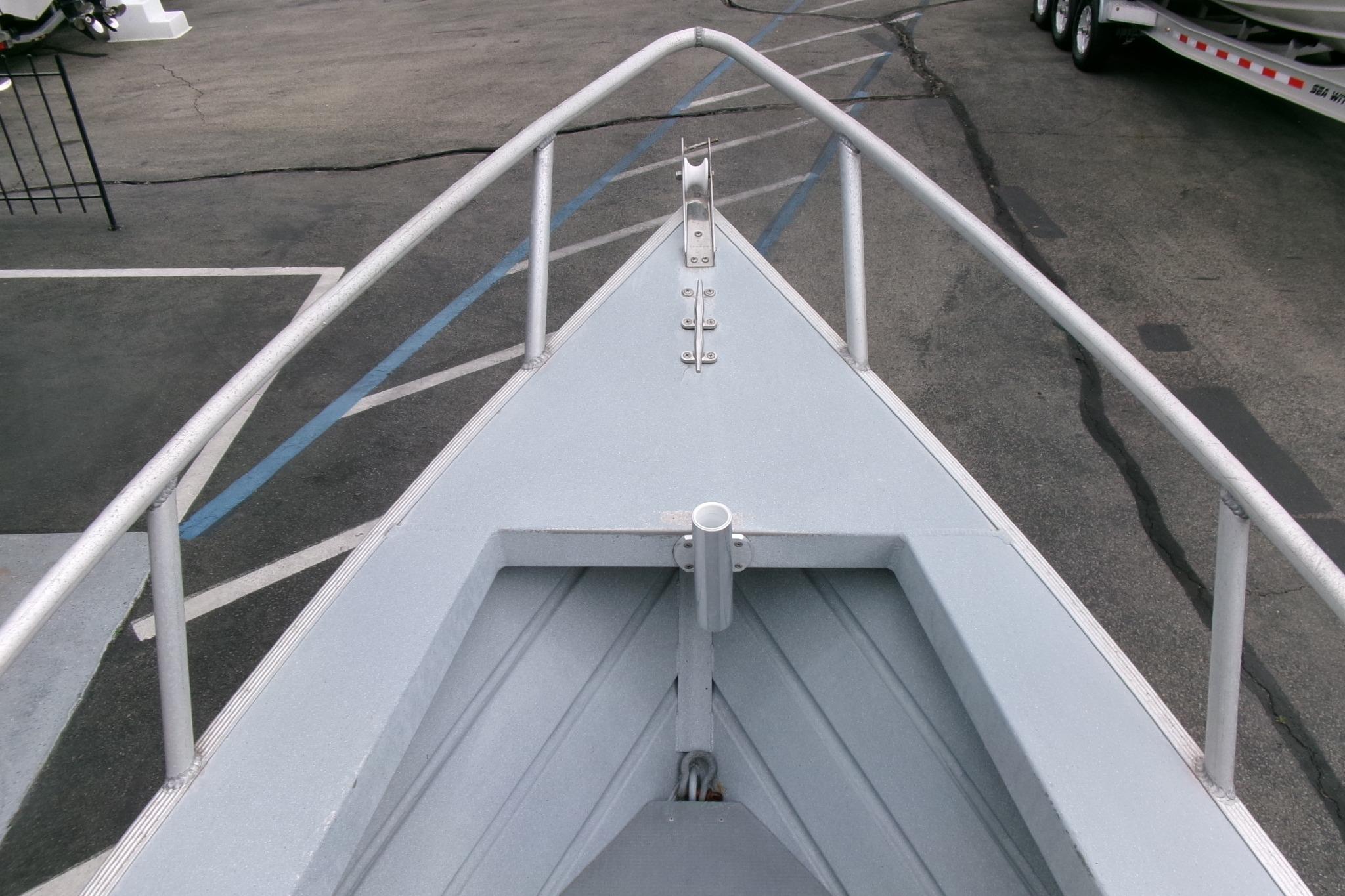 Bow view of 2017 Klamath Bayrunner 19 Baja boat in a parking lot.