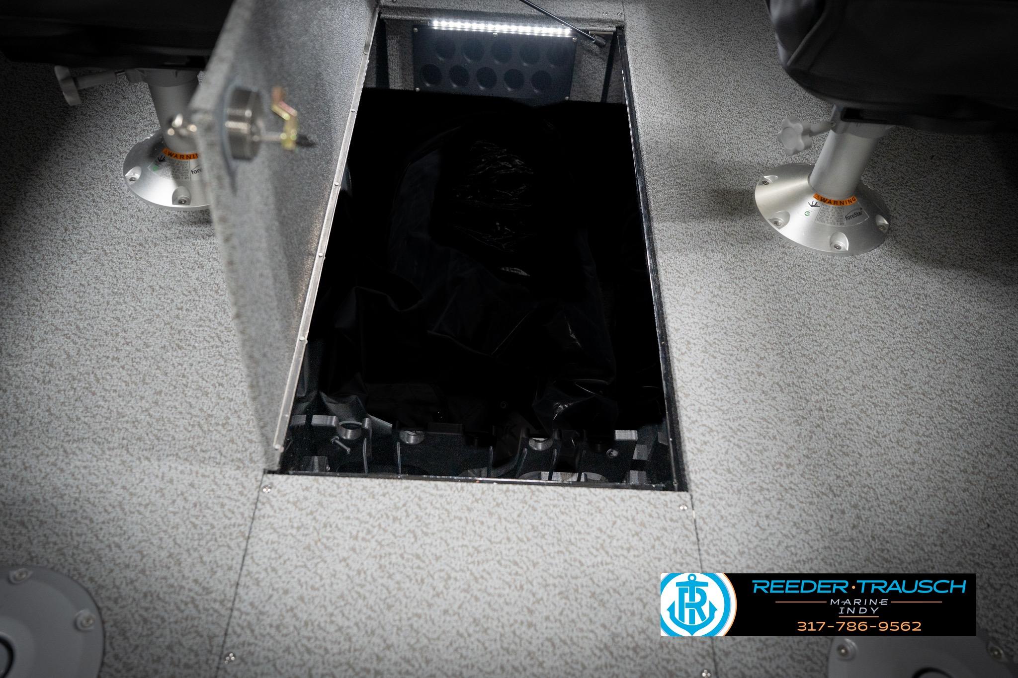Open storage compartment in 2026 Lund 2275 Baron boat interior.