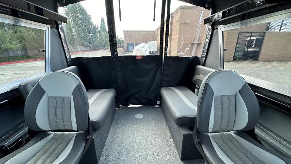 2024 Spartan 200 Astoria interior with gray seating and large windows.