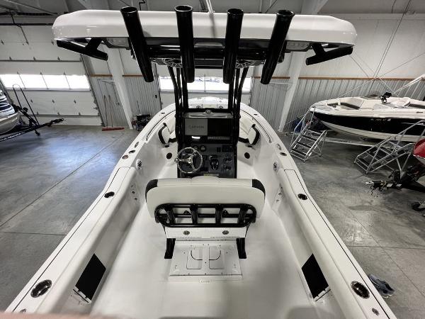 Interior view of a 2023 Tidewater 232 CC Adventure boat in a warehouse.