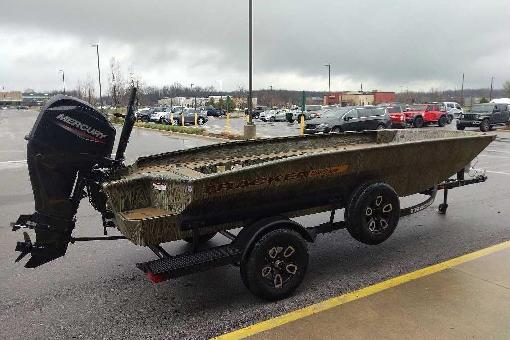 2026 Tracker Grizzly 1756 T Marsh boat with Mercury engine in parking lot.