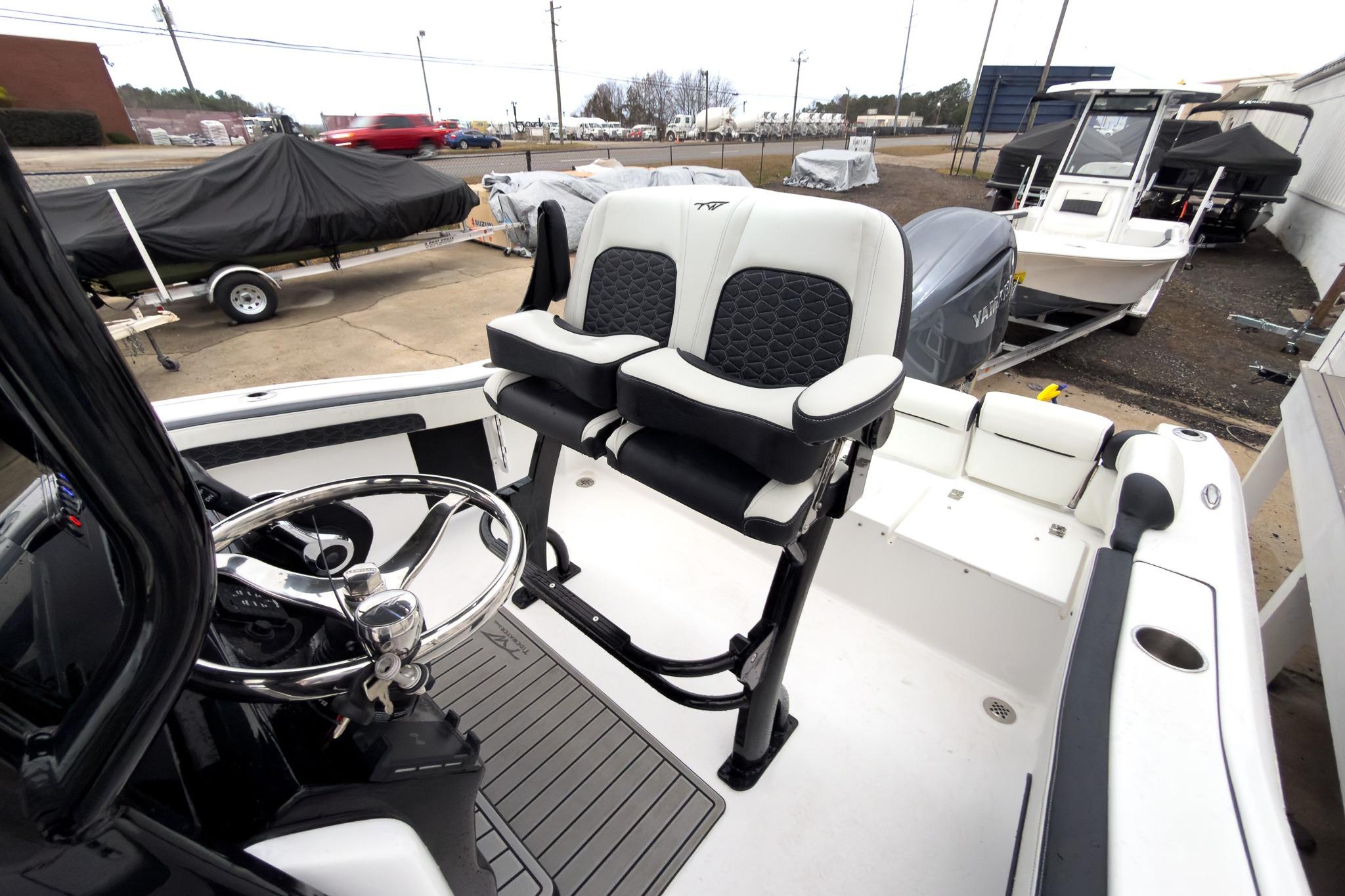 2026 Tidewater 210 LXF boat interior with steering wheel and seating.