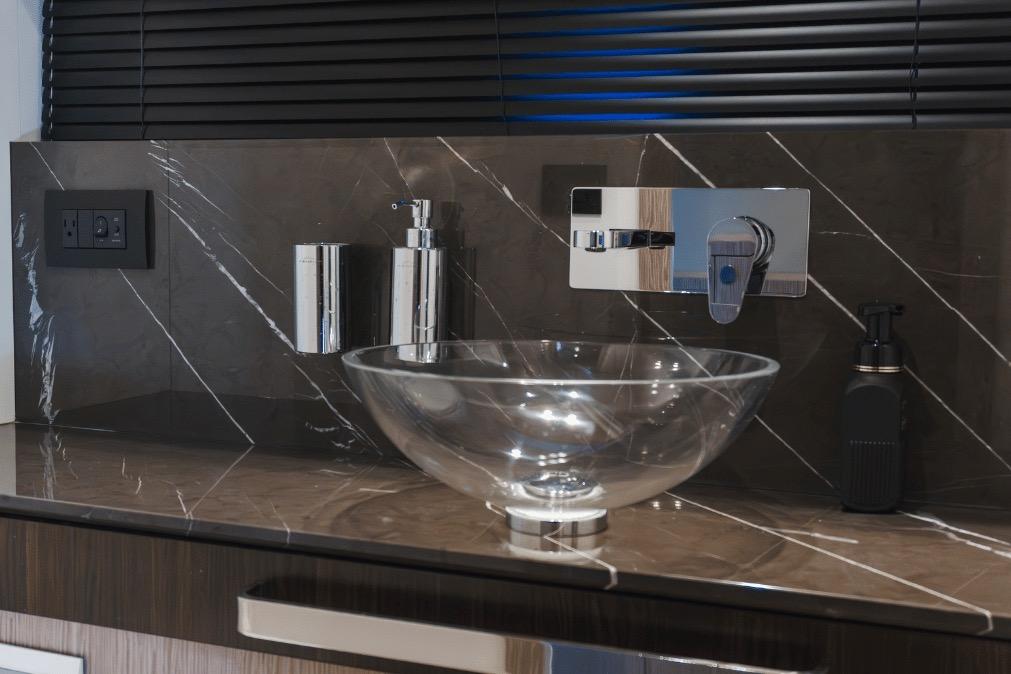 Luxury yacht Azimut 60 bathroom with modern glass sink and sleek fixtures, 2020 model.