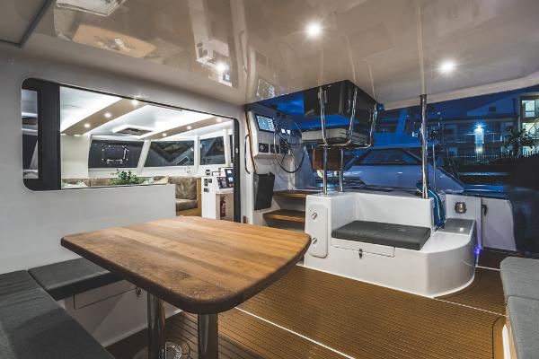Modern Vision 444 yacht interior, featuring sleek design, wooden table, and ambient lighting, 2026 model.