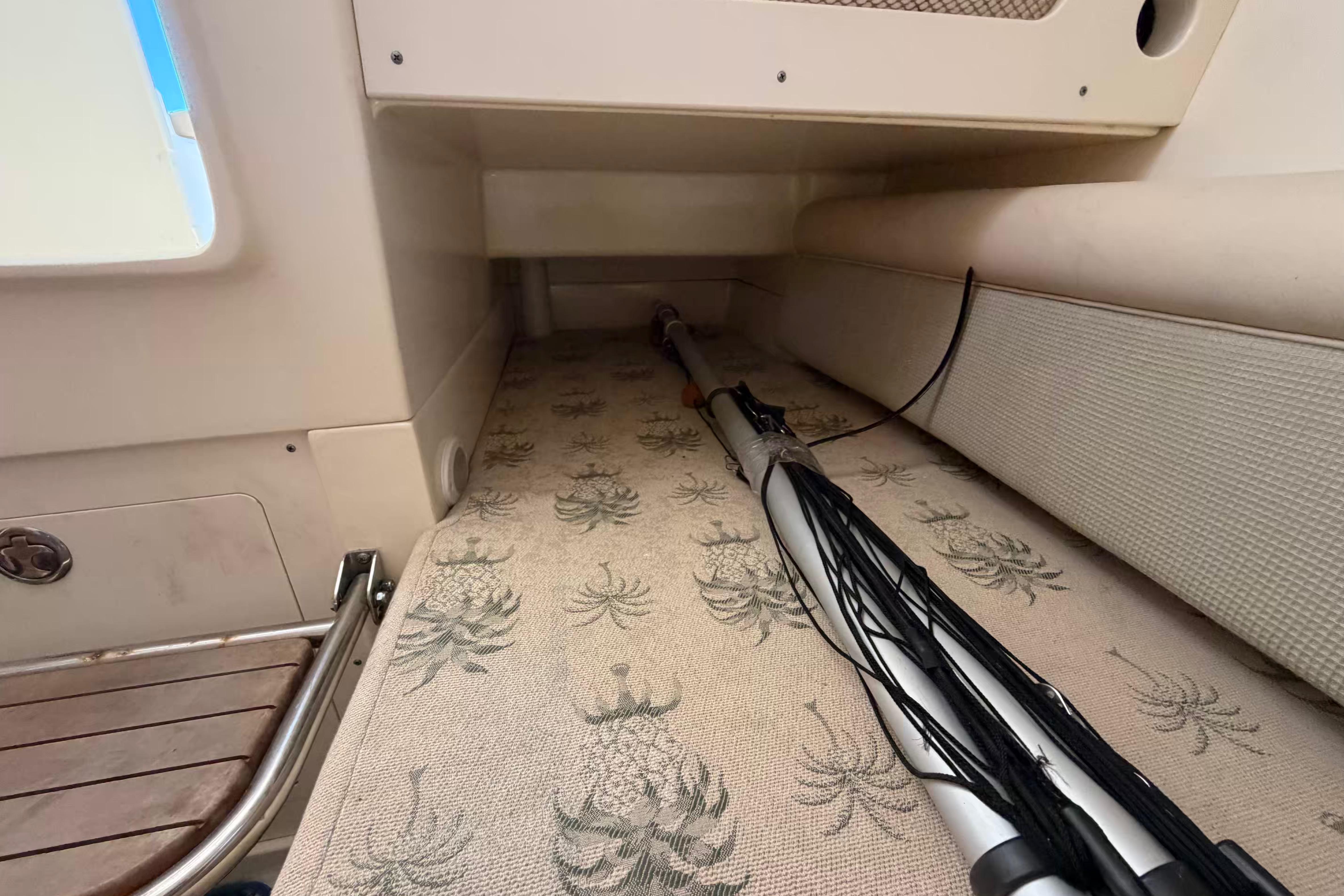 Interior view of a 2007 Scout 262 Abaco boat, featuring storage space and patterned flooring.