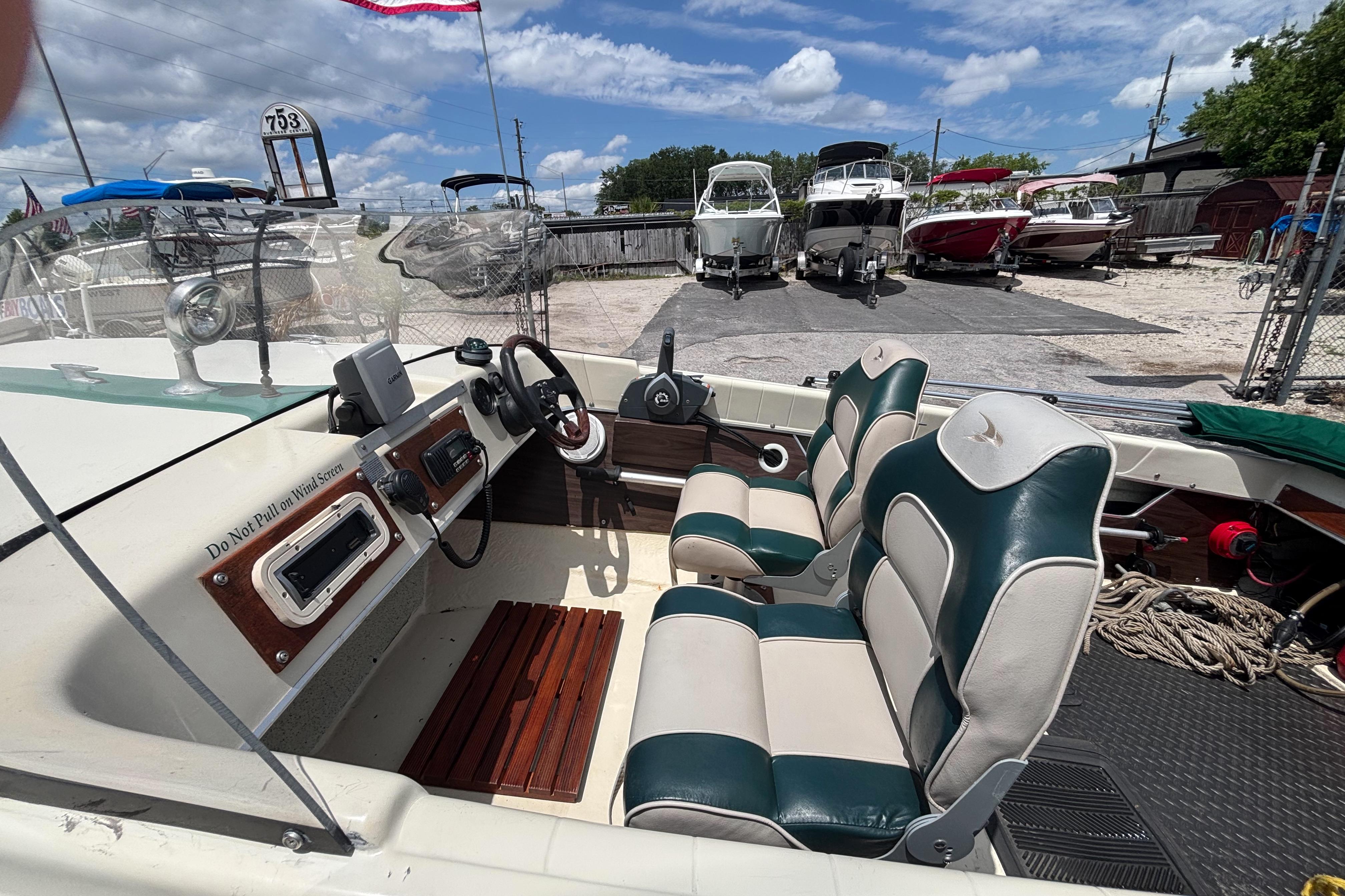 1966 Mohawk 15 boat interior with vintage dashboard and dual-tone seating at a marina.