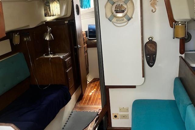 Interior of a 1979 Pearson 365 Ketch sailboat, featuring cozy seating and nautical decor.