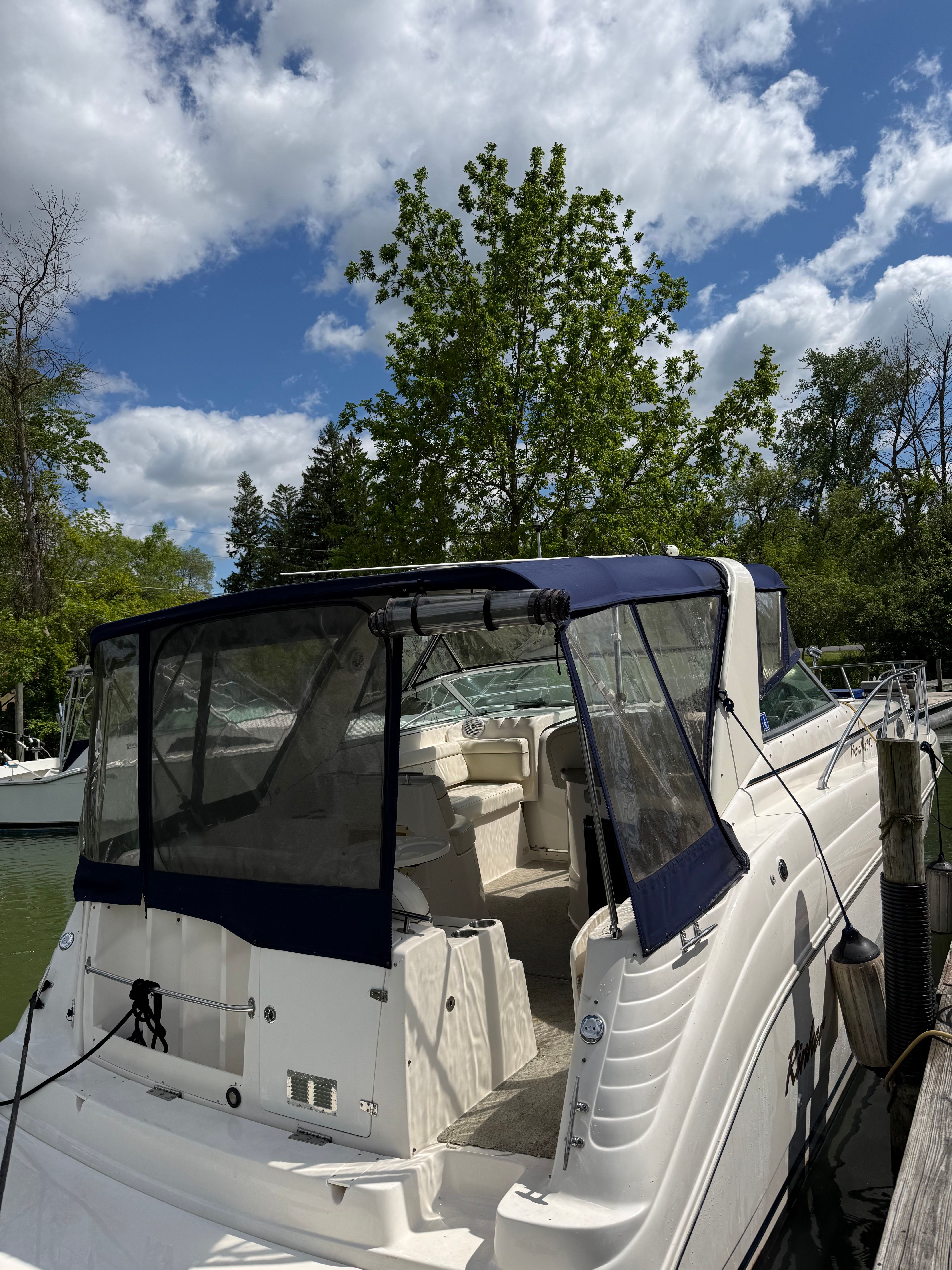 2002 Rinker Fiesta Vee 342 boat docked on a sunny day.