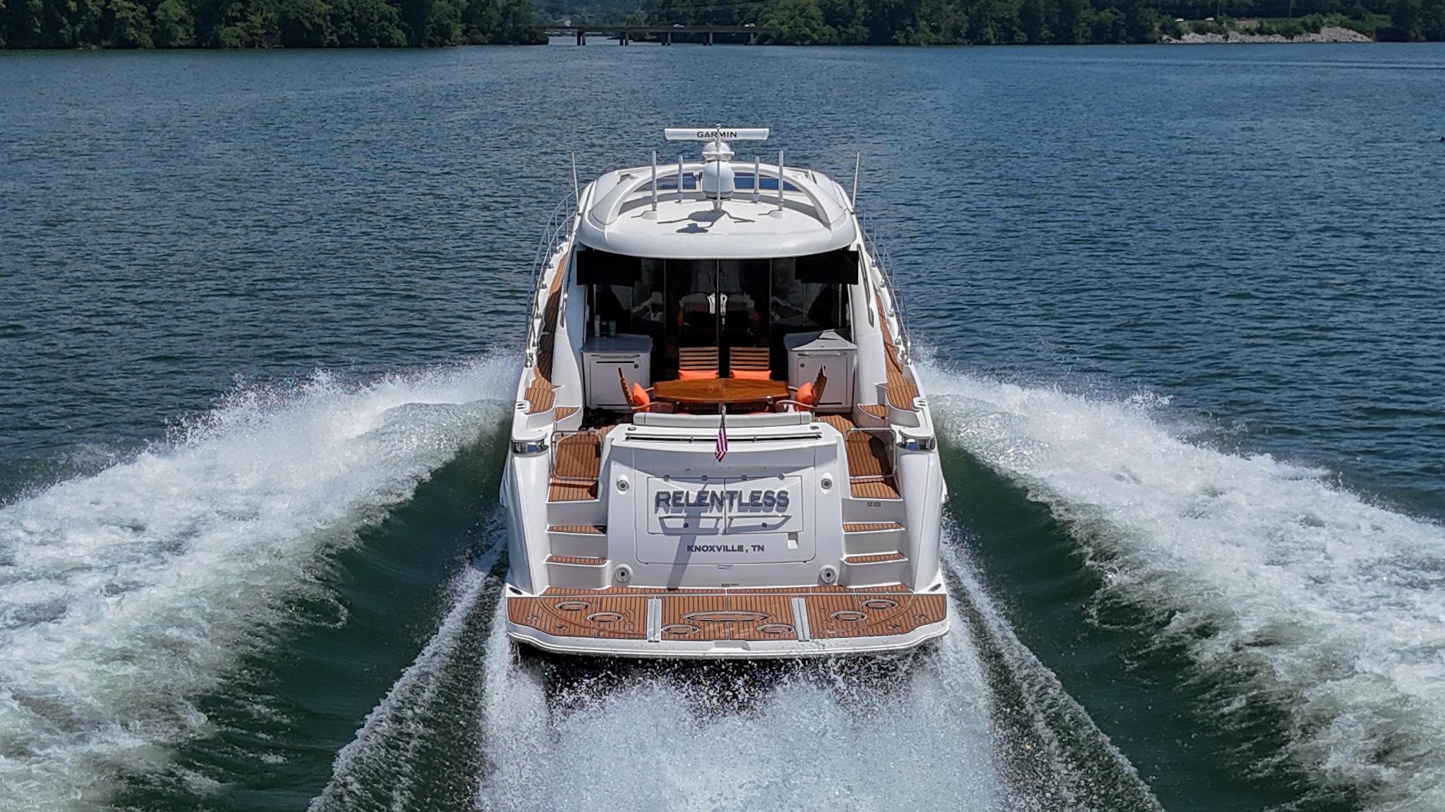 2007 Sea Ray 60 Sundancer yacht cruising on a serene lake.