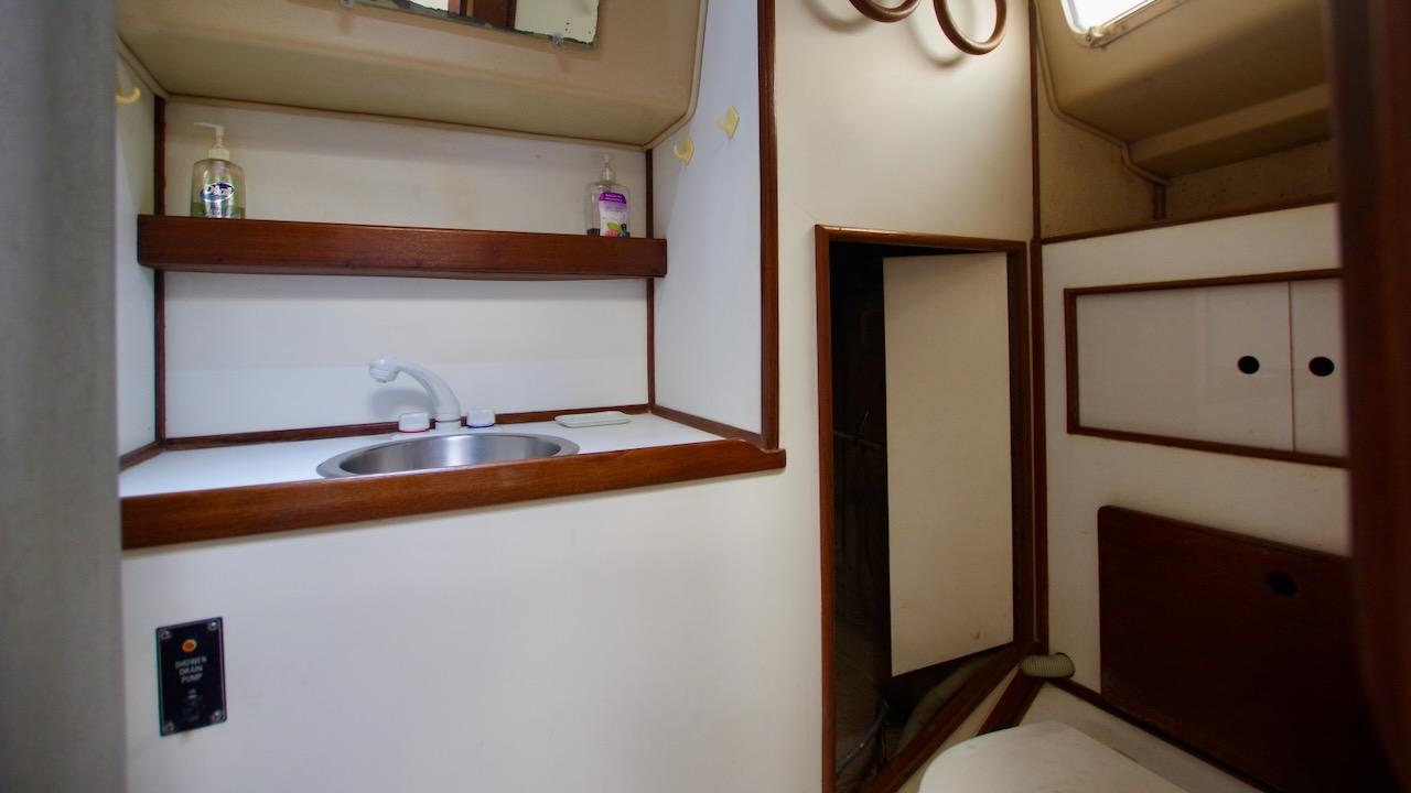 1981 Morgan Out Island 41 yacht interior with sink and storage shelves.