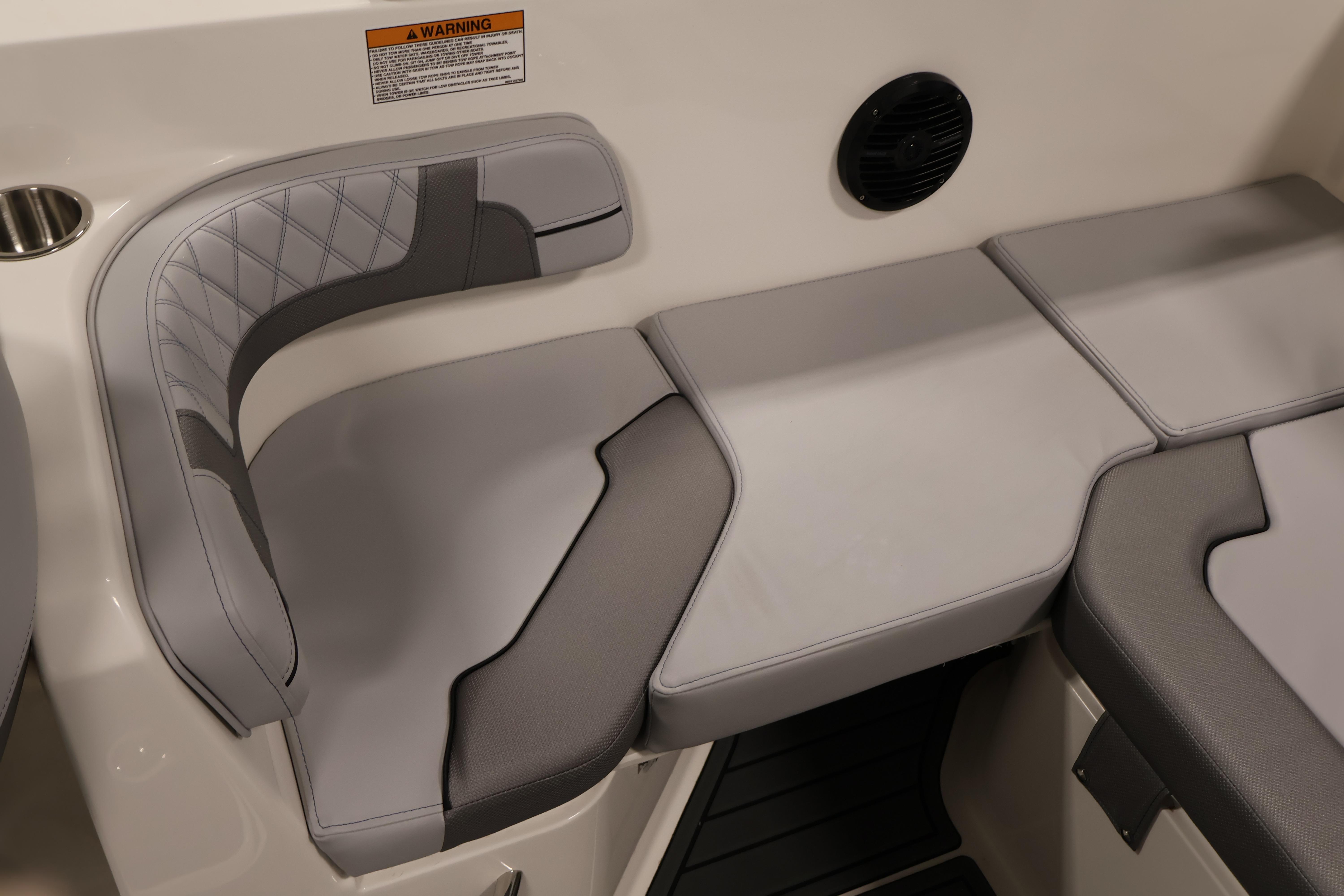 2026 Bayliner VR6 Bowrider I/O interior seating with gray upholstery and speaker.