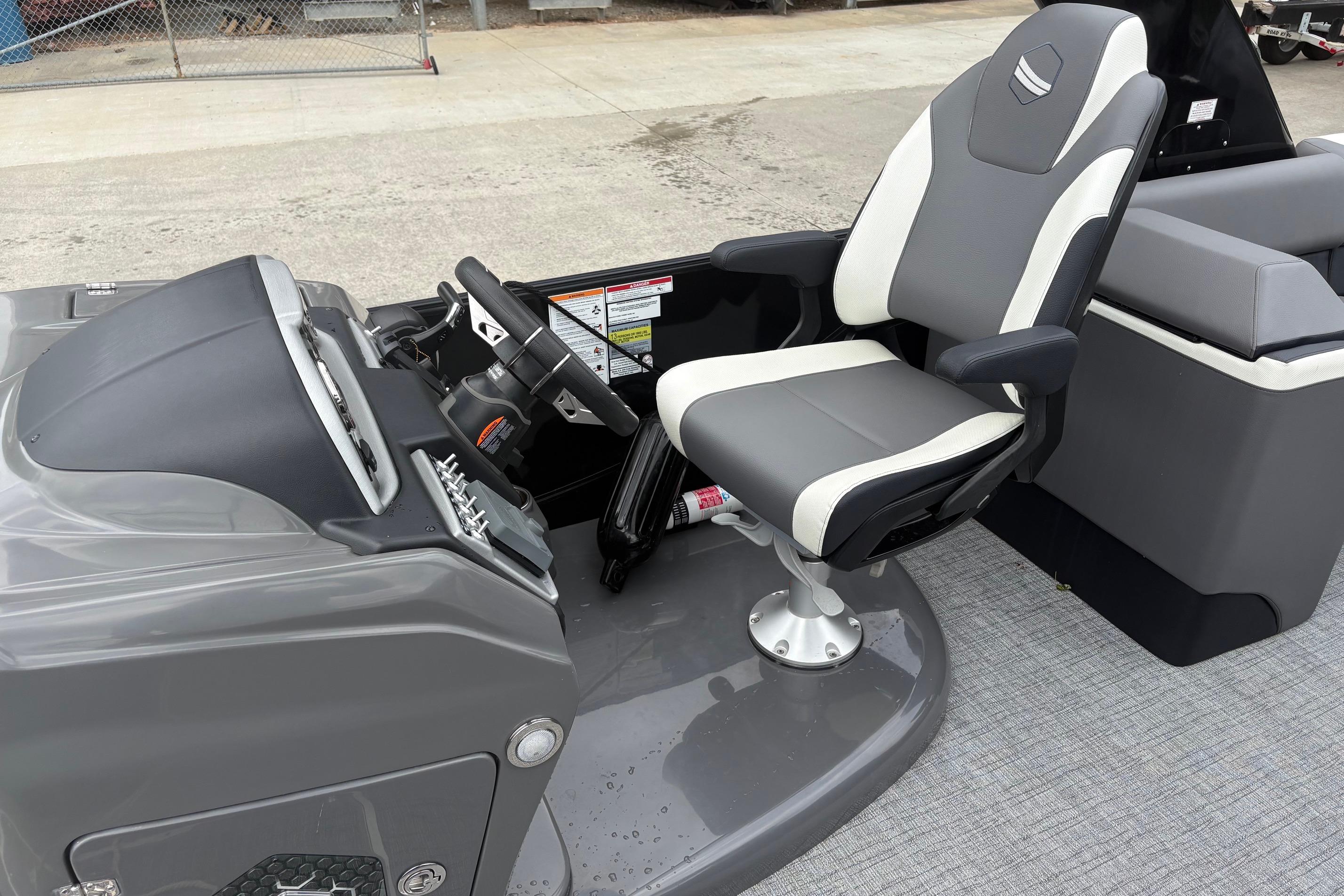 2023 South Bay 525 RS 3.0 Arch boat interior with captain's chair and steering console.