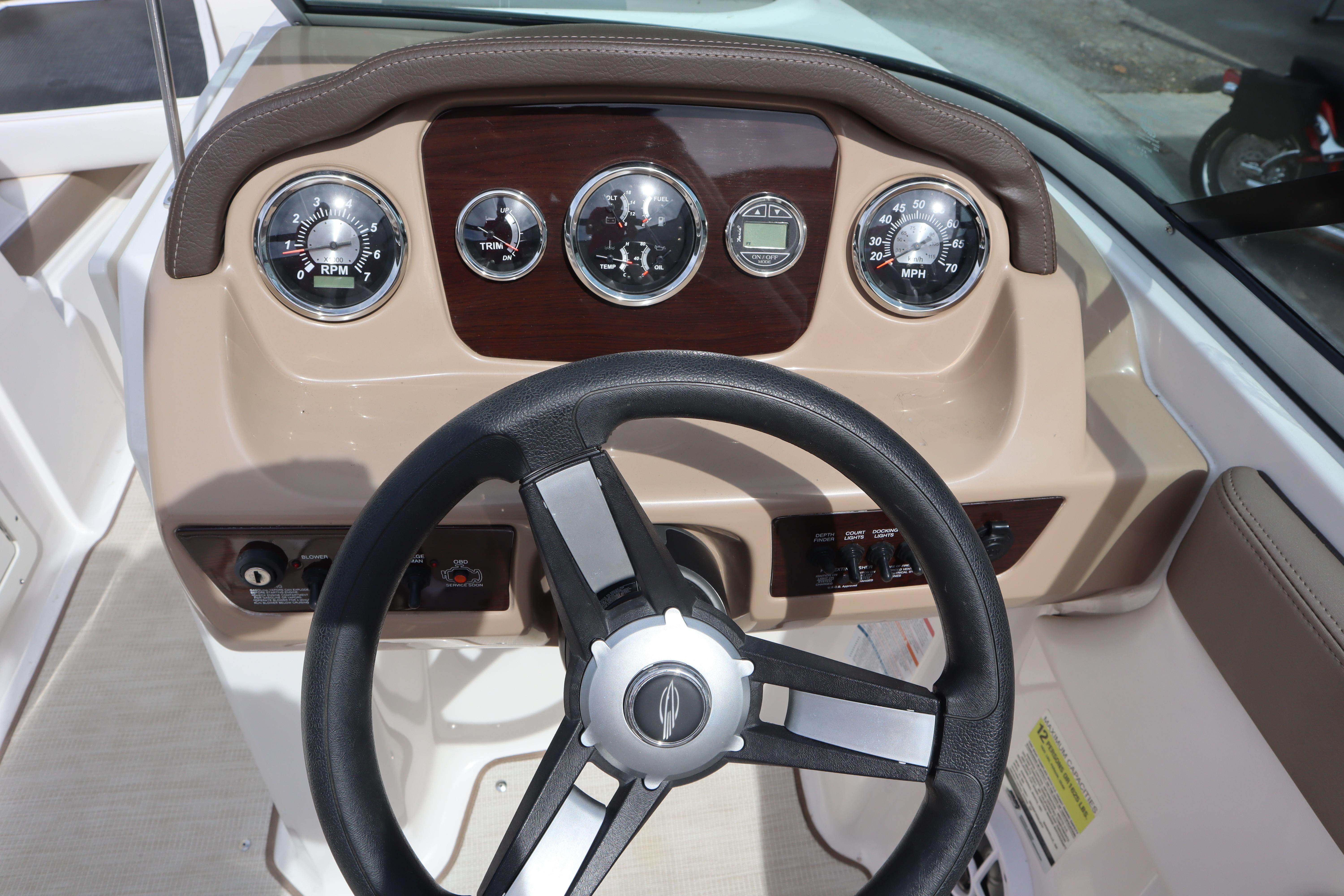 Dashboard of 2021 Chaparral 21 SSi boat with steering wheel and gauges.