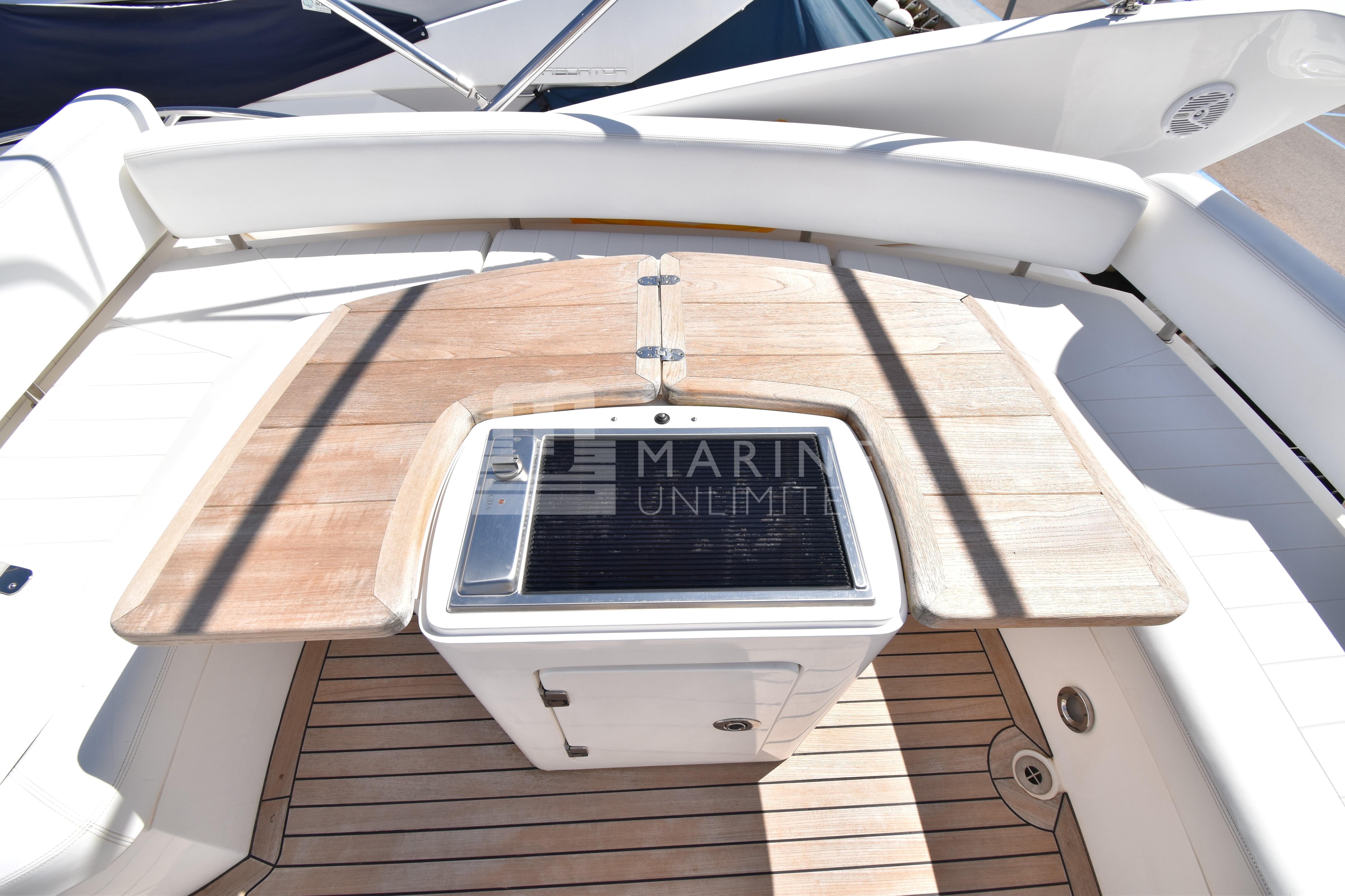 Sunseeker Manhattan 52 yacht deck with wooden table and seating, 2010 model.