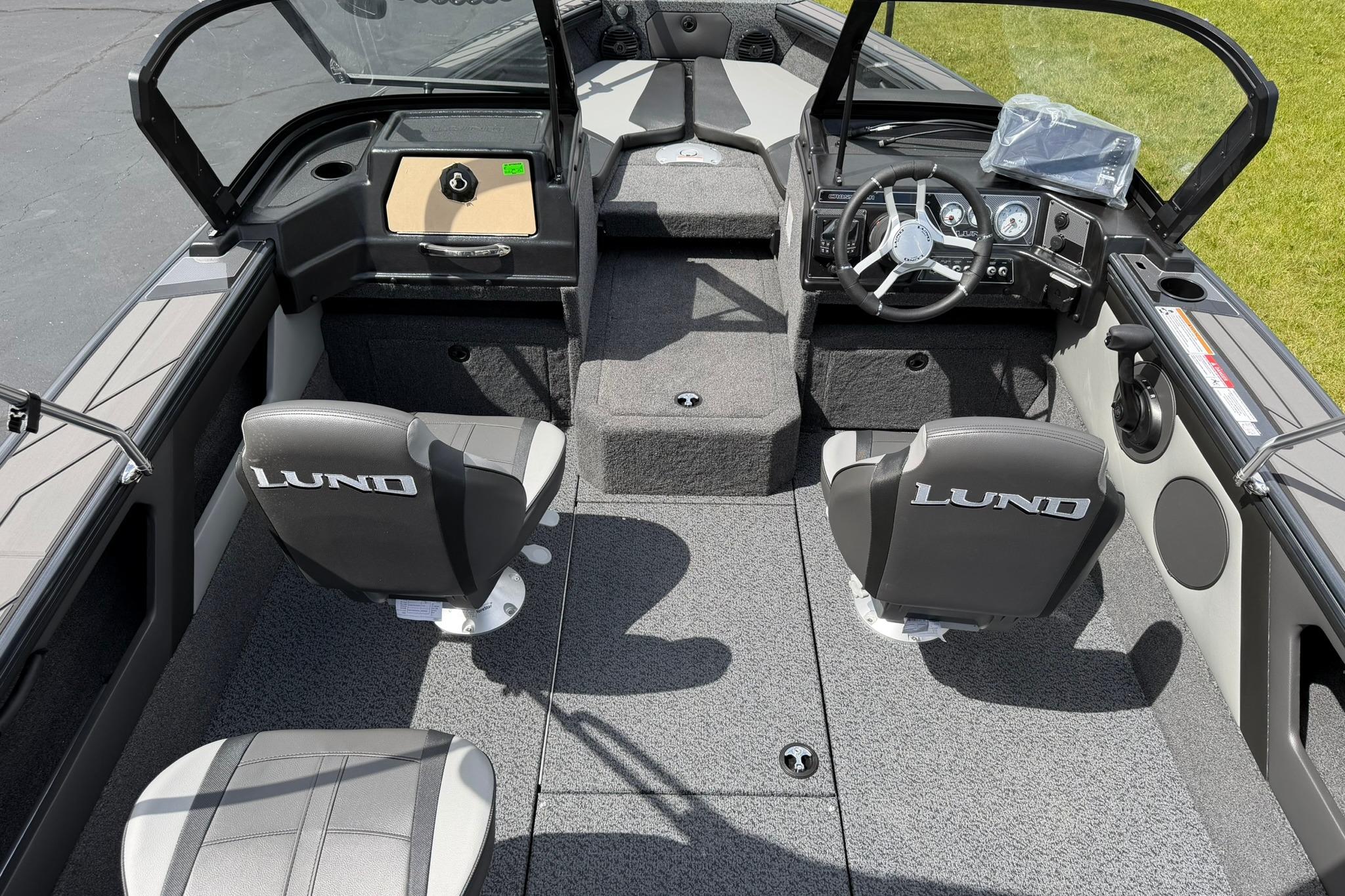 2027 Lund 1875 Crossover XS boat interior with steering wheel and seating.