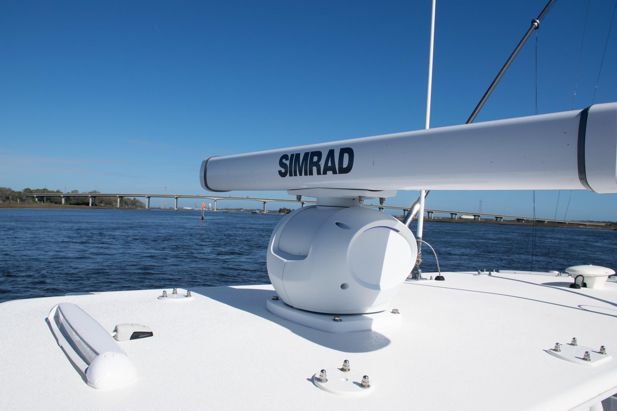 2022 SeaVee 322Z boat with Simrad radar on calm water, bridge in background.