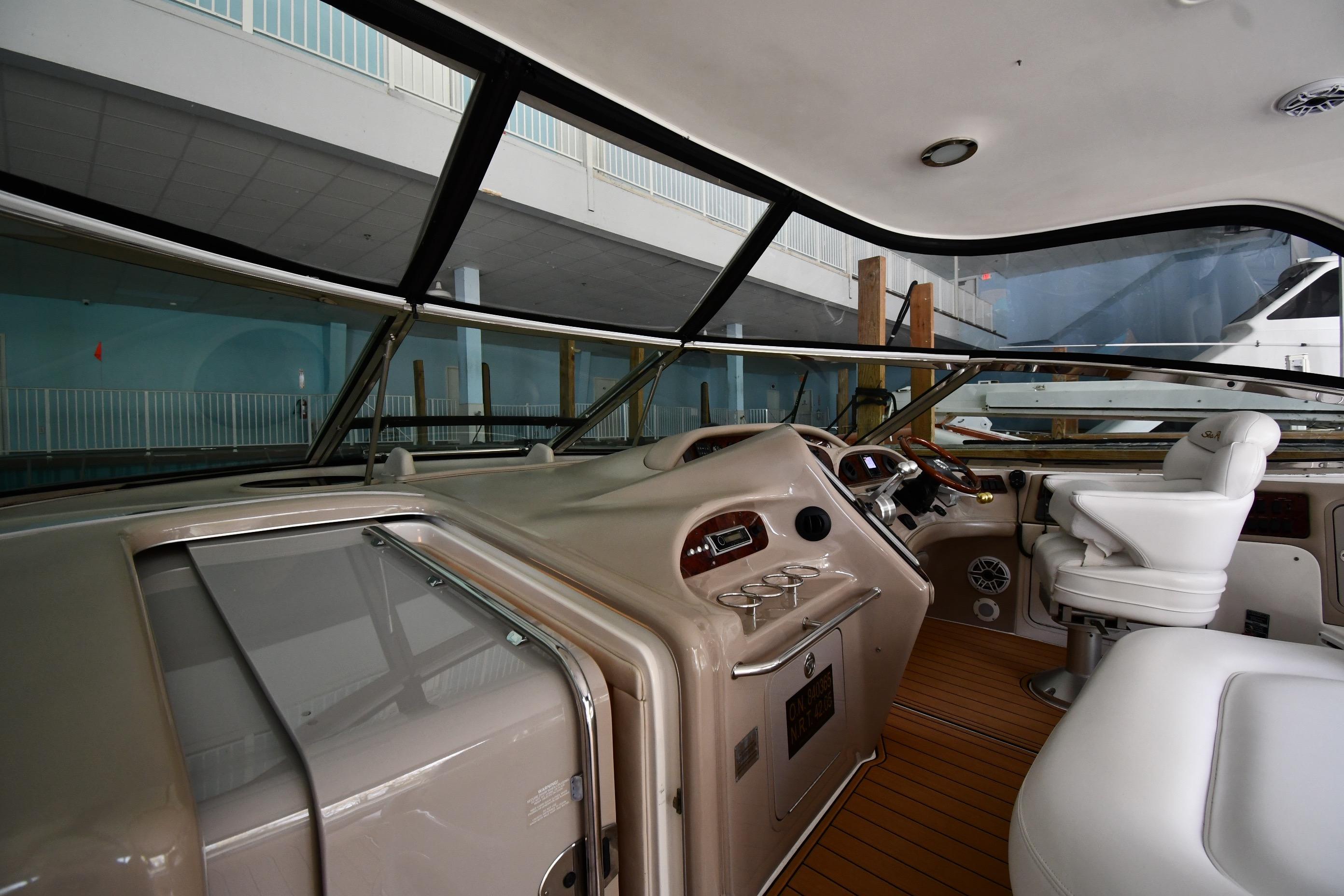 Interior view of 2001 Sea Ray 540 Sundancer yacht cockpit with steering and seating.