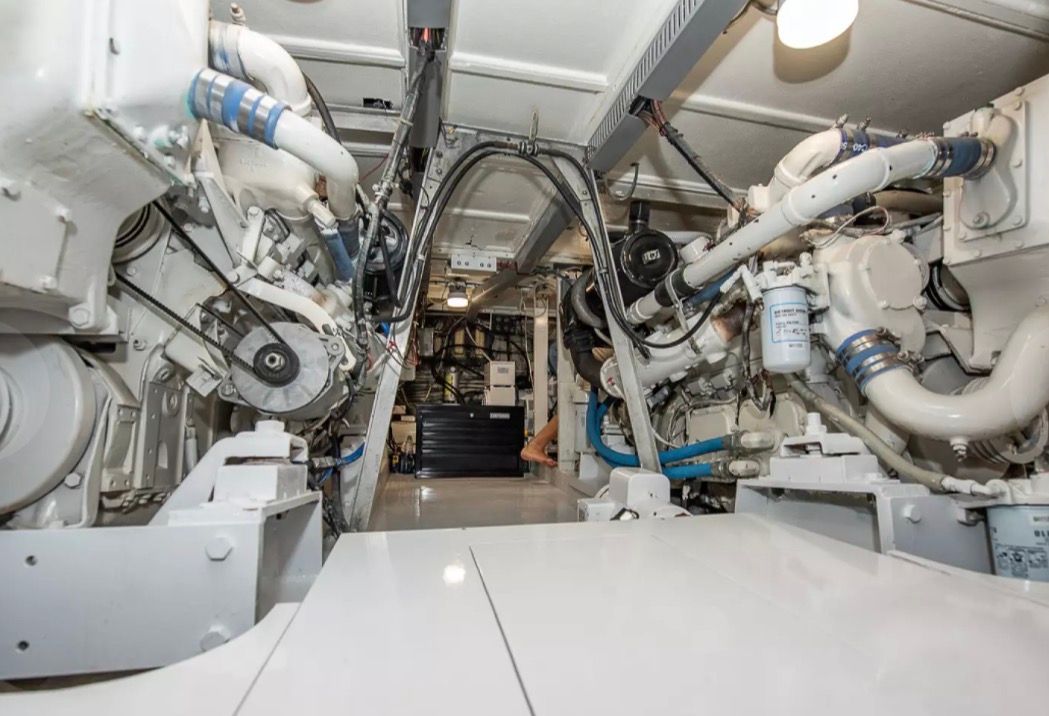 The engine room of a 1979 Hatteras sport fishing yacht with complex machinery and piping.