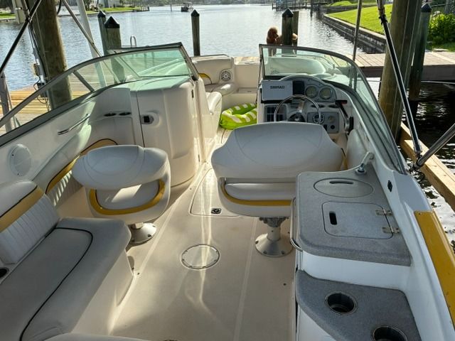 The image shows the cockpit of a 2008 Hurricane Sun Deck 24 with white seating and a helm station.