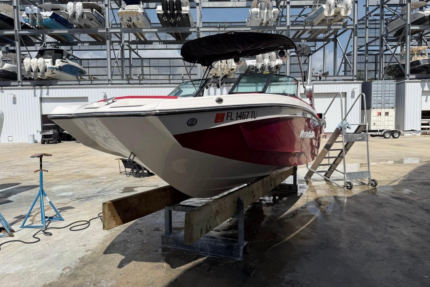 2023 MasterCraft X24 boat on dry dock in marina storage facility.