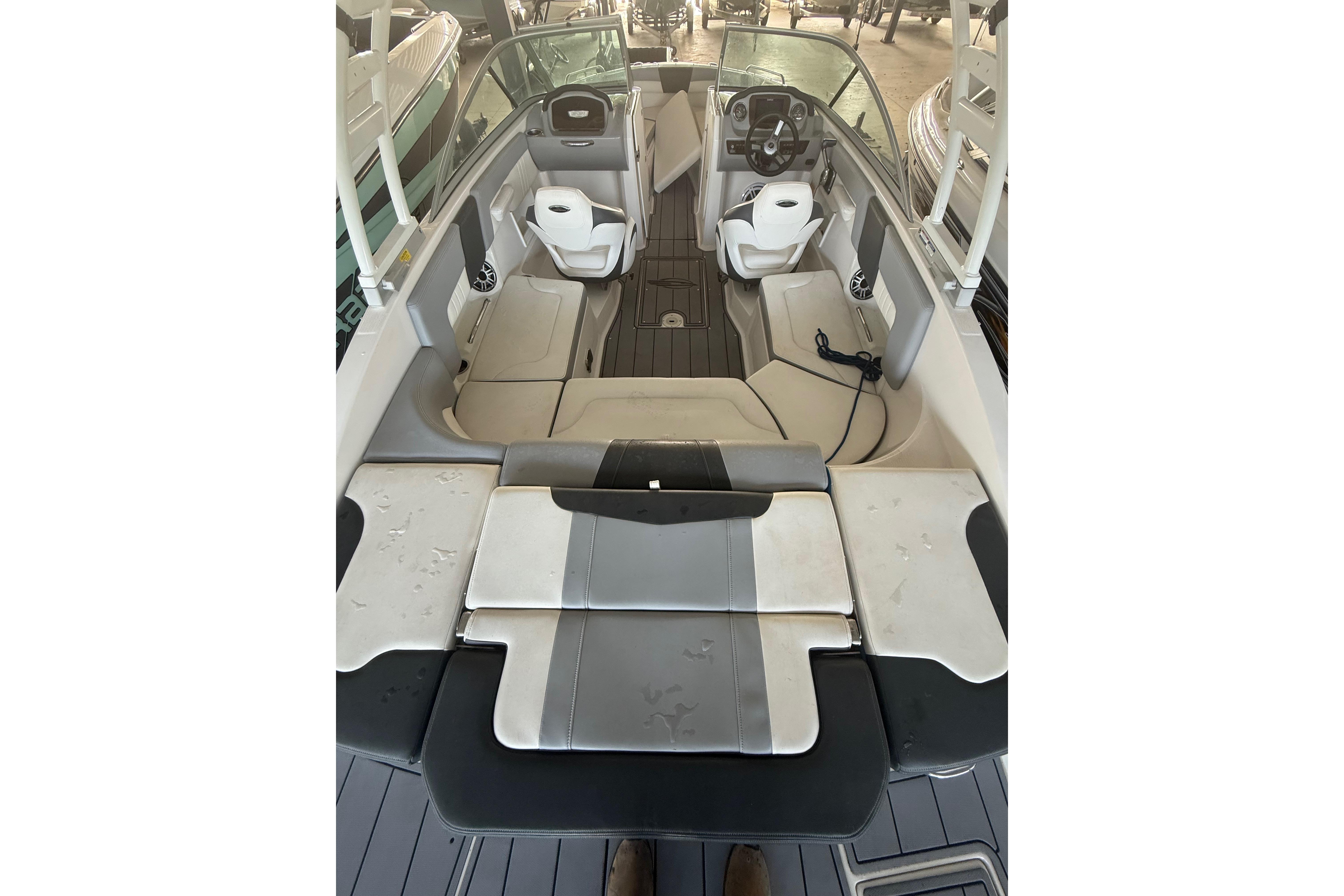 2023 Chaparral 230 SSi boat interior with modern seating and steering wheel.
