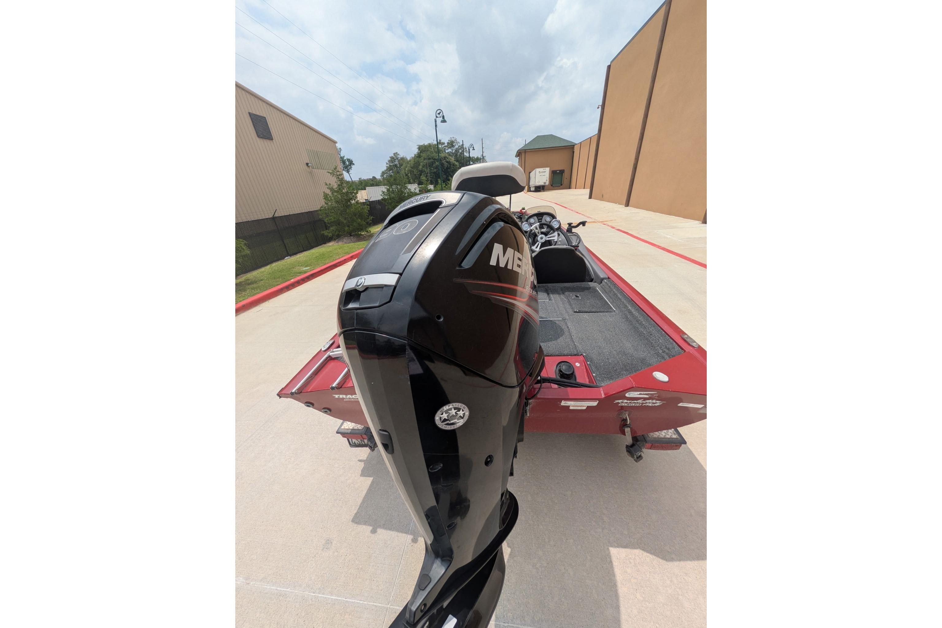 2019 Tracker Pro Team 190 boat with Mercury outboard motor, parked outdoors.