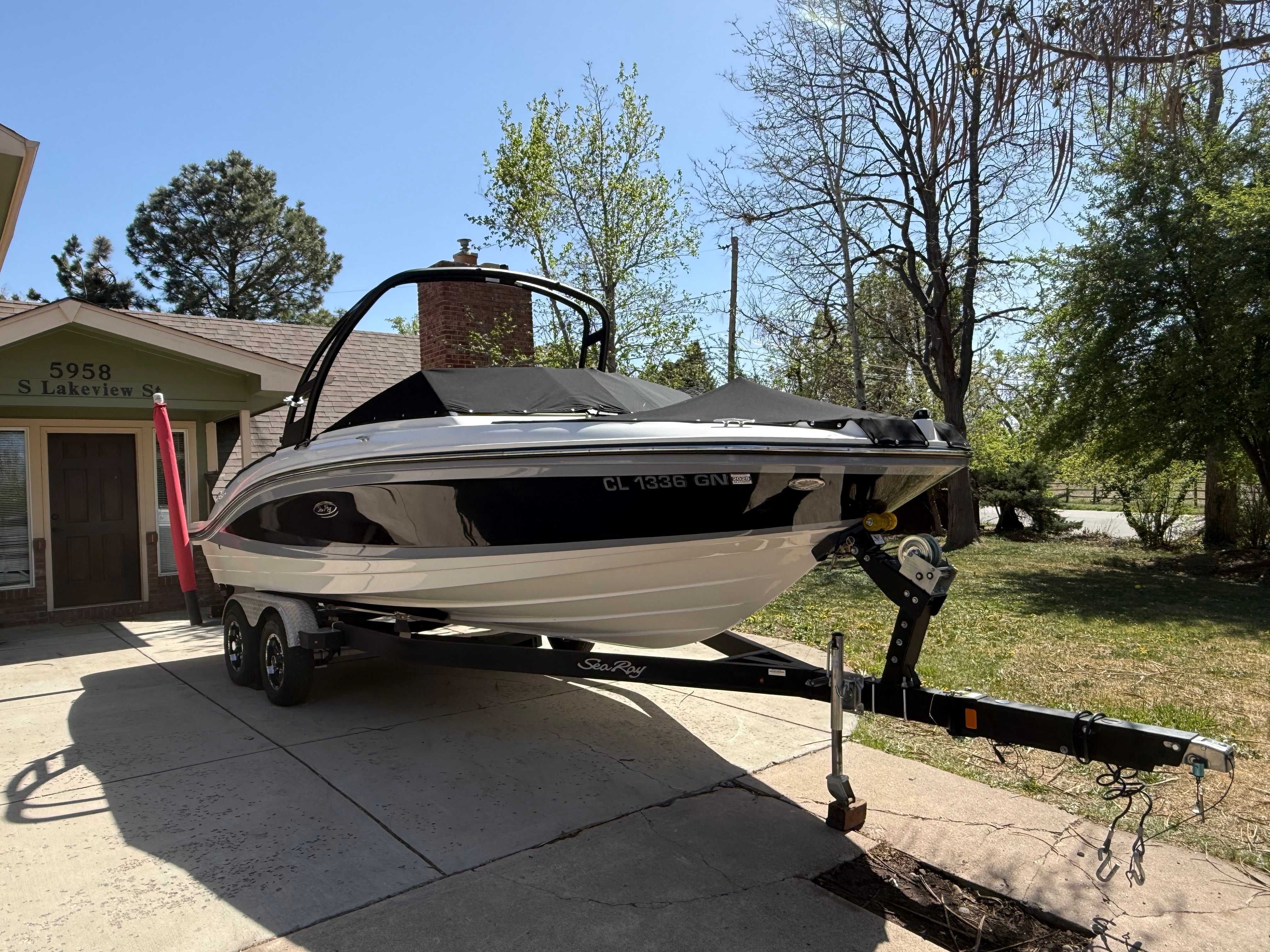 2022 Sea Ray SPX 210 boat on trailer parked in driveway.