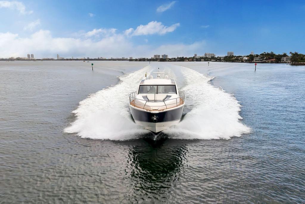 2012 Fairline Targa 58 yacht cruising on open water under a clear blue sky.