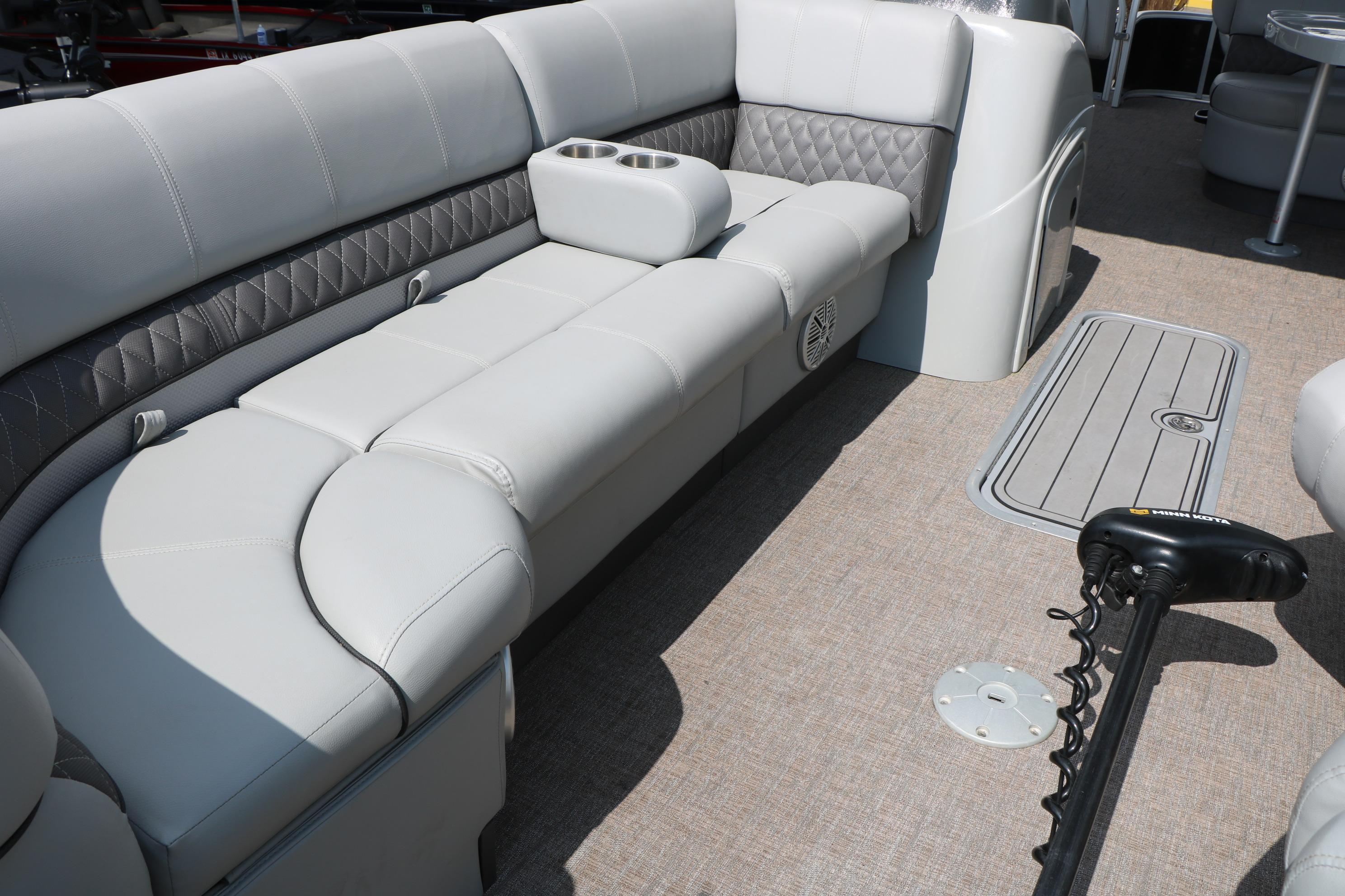 Luxurious seating on 2021 Ranger 223FC boat with beige upholstery and integrated cup holders.