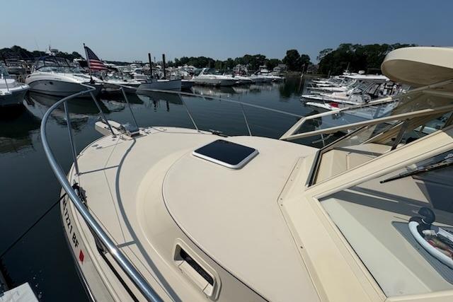 2003 Albin 28 Tournament Express boat docked in a marina, surrounded by other vessels.