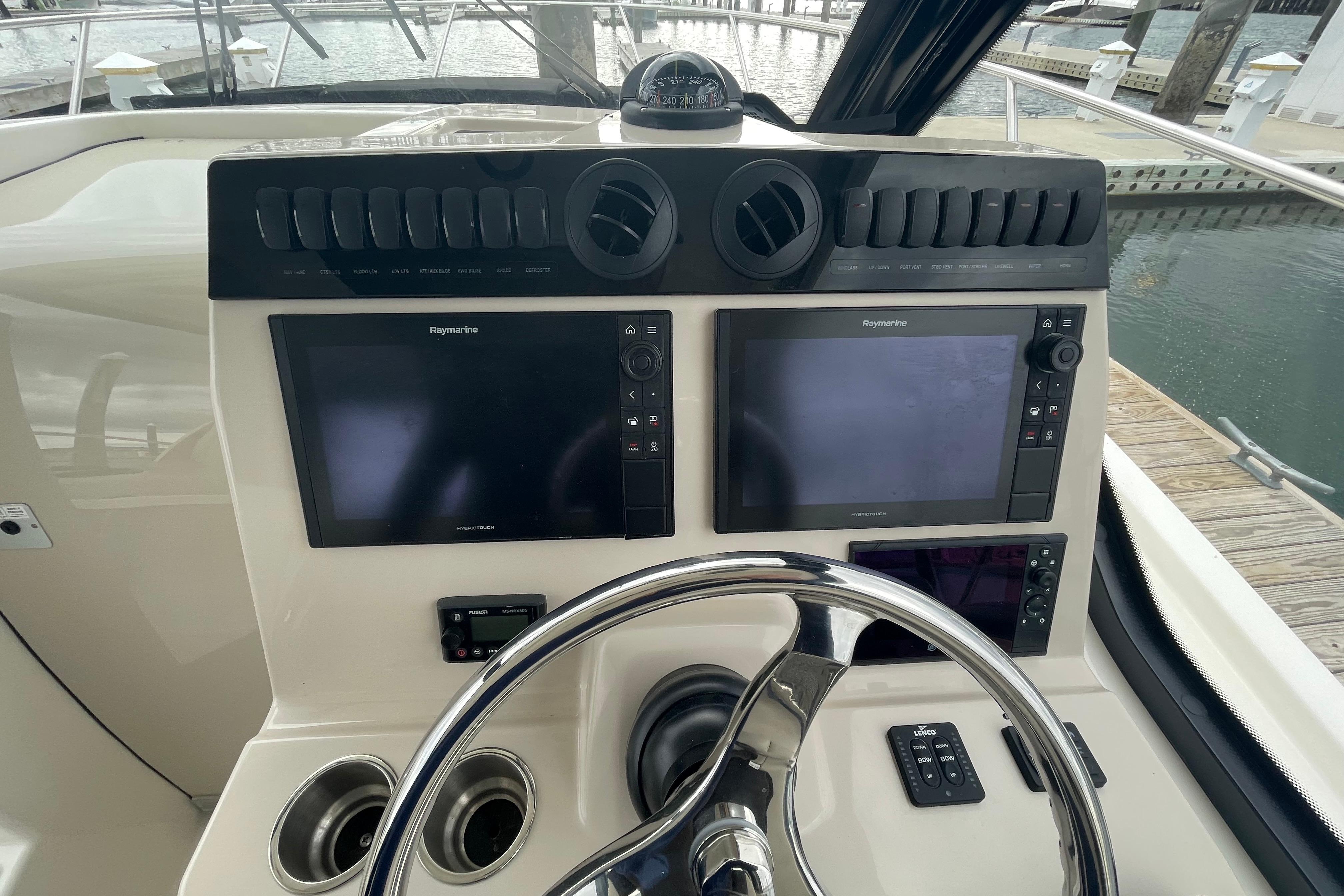 Control panel of 2023 Boston Whaler 325 Conquest boat with dual Raymarine displays.