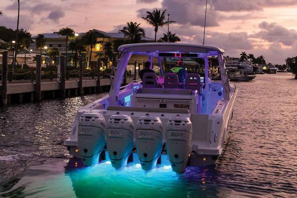 Manufacturer Provided Image: 2020 Boston Whaler 420 Outrage boat with illuminated engines at sunset.