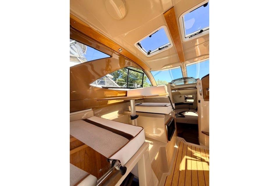 Interior of 2017 Cutwater C-242 Coupe boat with wood accents and seating.