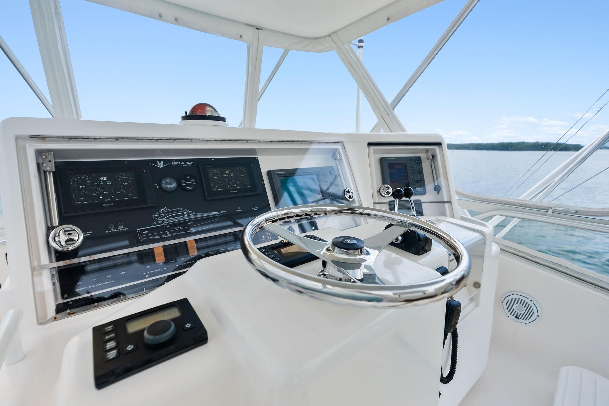 2006 Bertram 39 Convertible yacht helm with steering wheel and navigation controls.