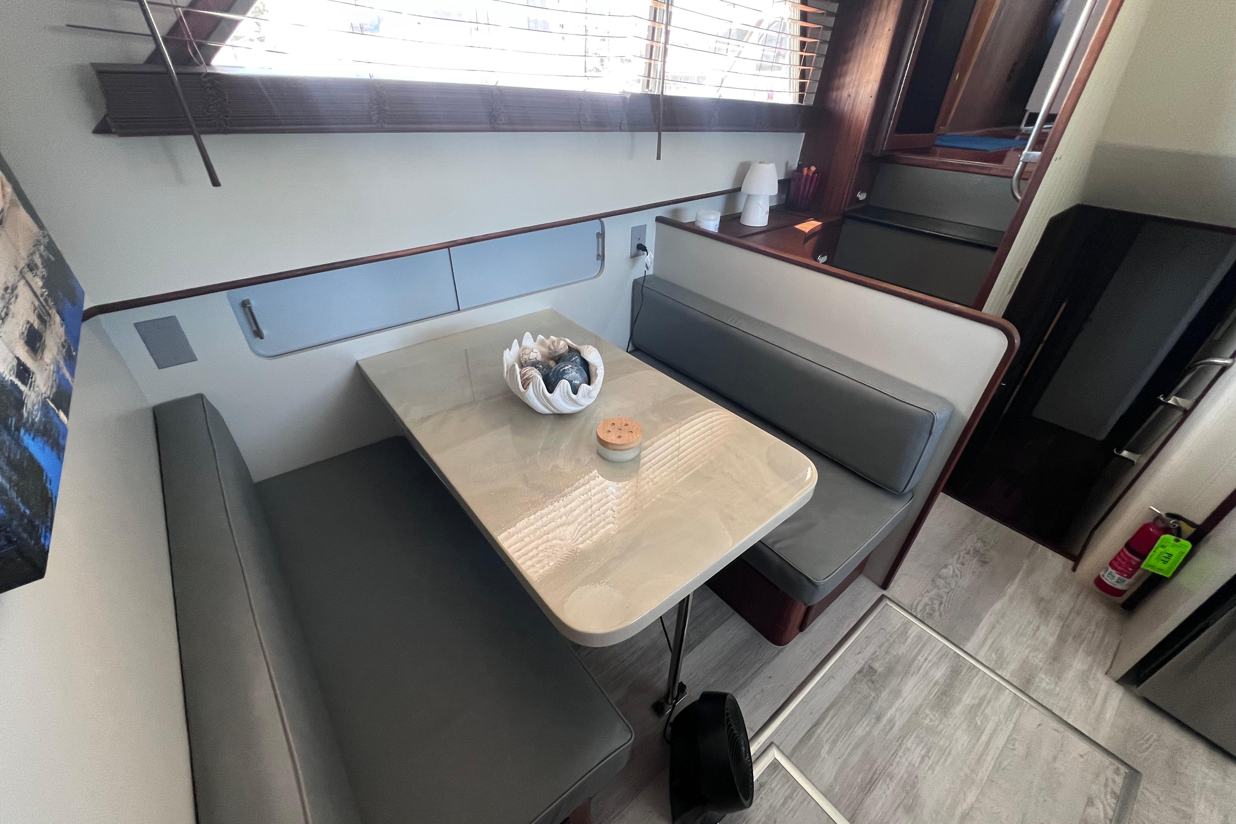 Interior of 1987 Hatteras 70 Cockpit Motor Yacht with dining area and seating.