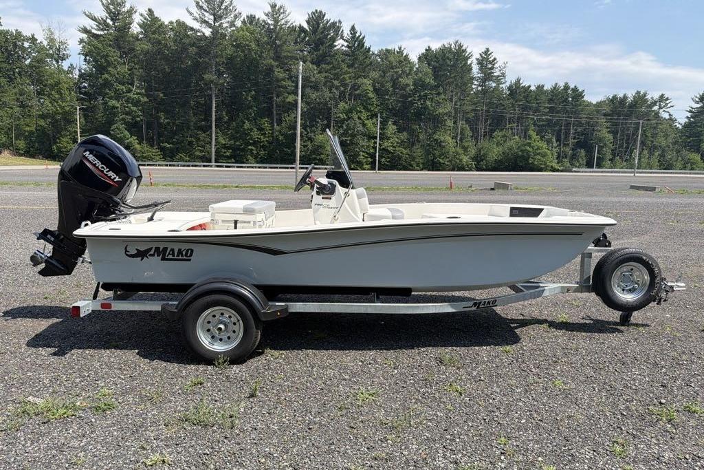 2026 Mako Pro Skiff 15 CC boat on trailer, parked outdoors.