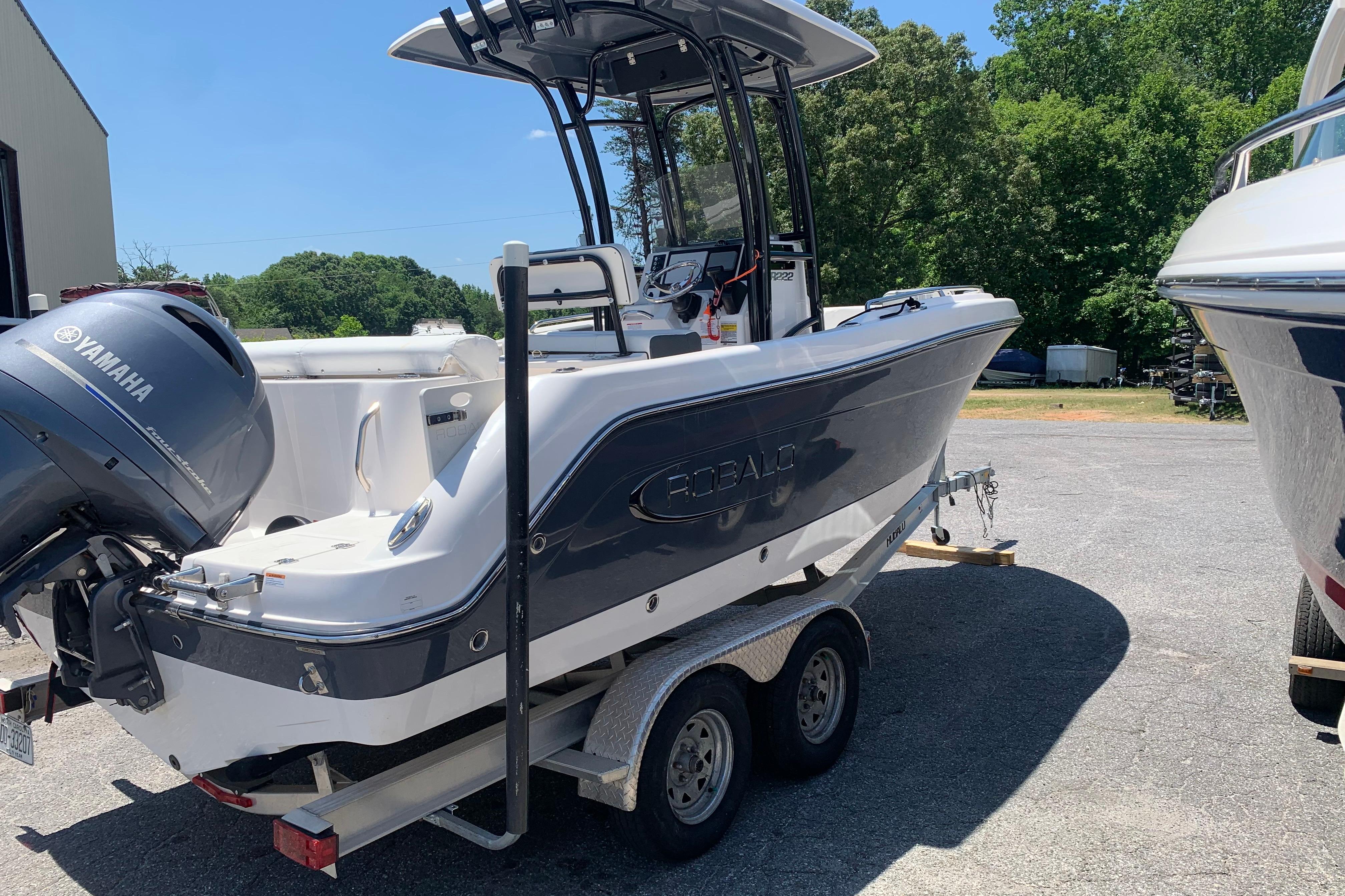 2023 Robalo R222 Center Console boat with Yamaha engine on trailer.
