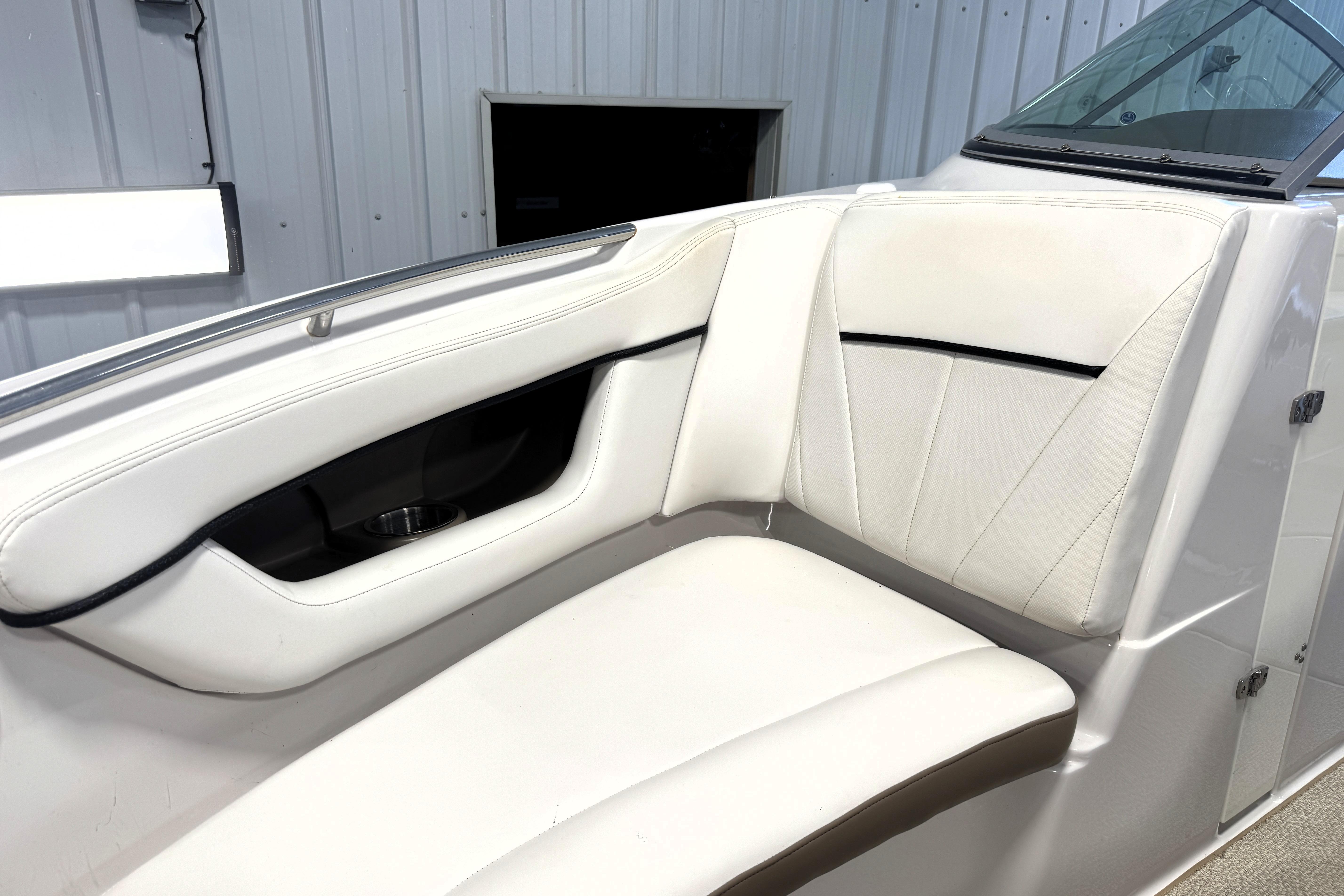 2008 Four Winns H240 boat interior with white cushioned seating and sleek design.