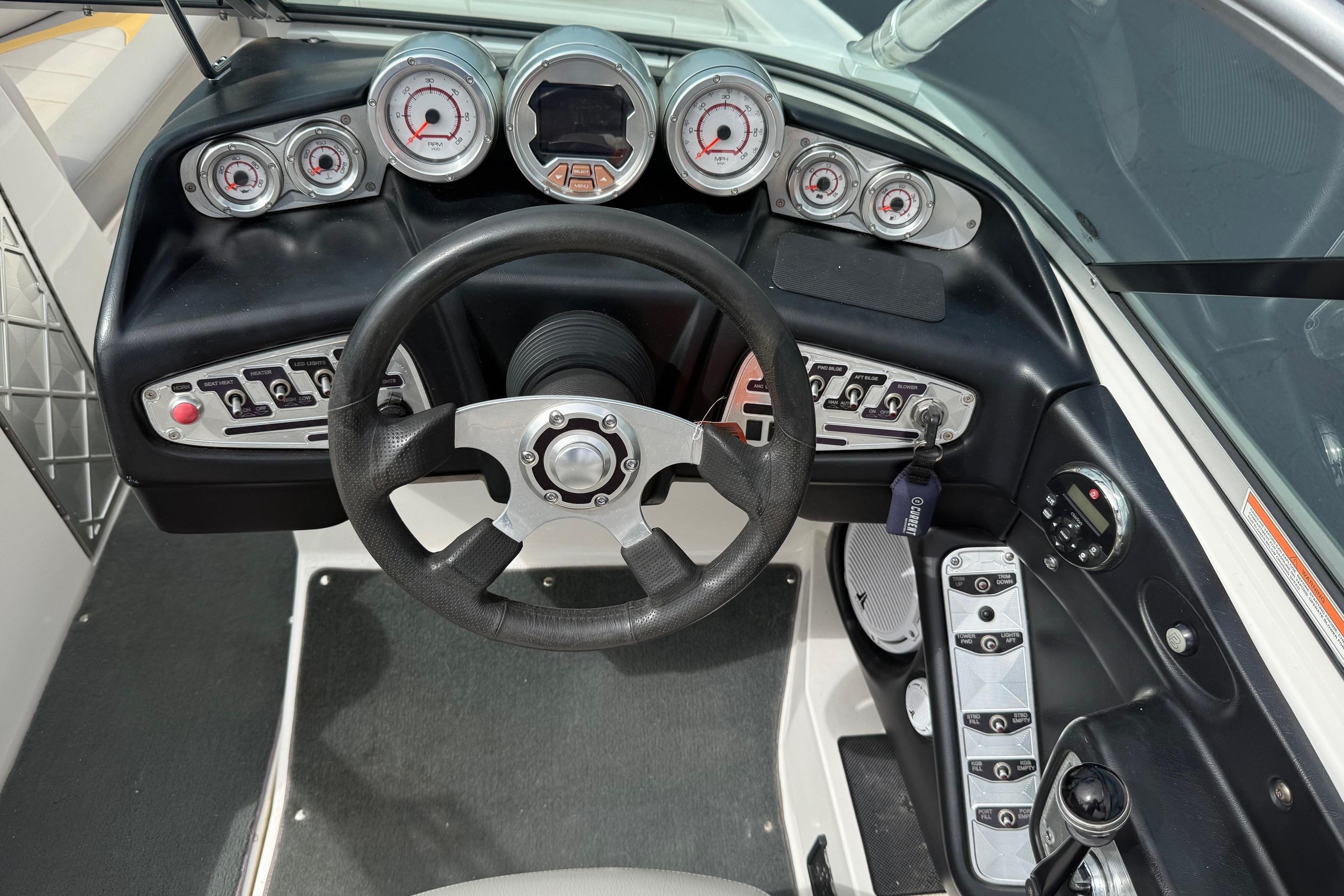 Dashboard of a 2008 MasterCraft X-15 boat with steering wheel and gauges.