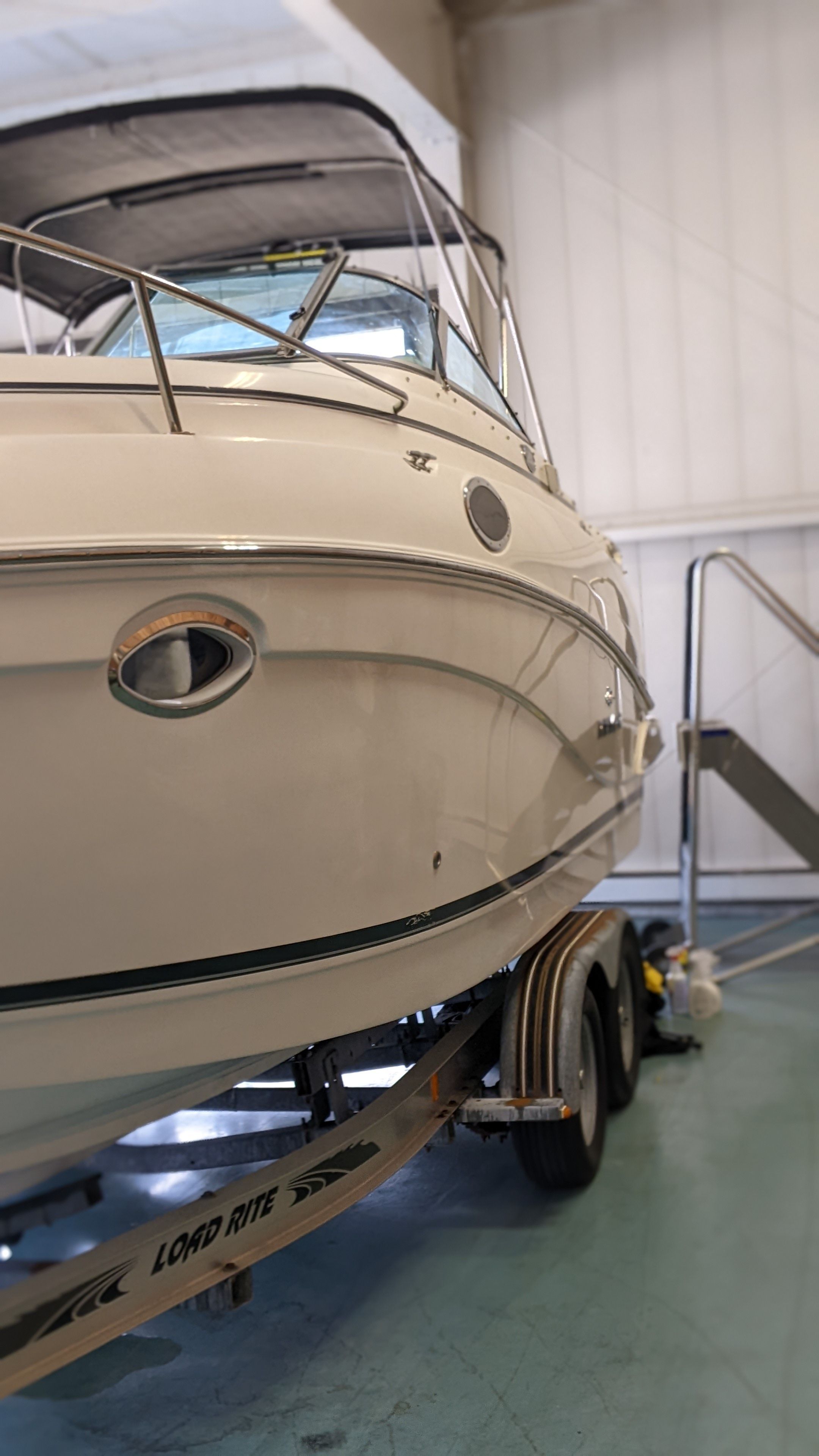 2006 Rinker 250 EC boat on trailer in storage facility.
