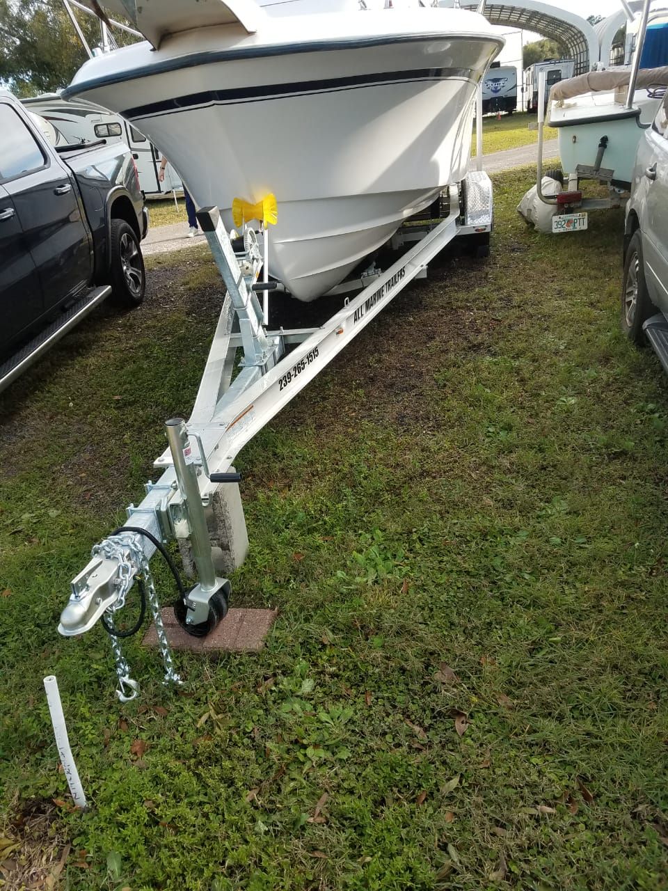 A 1995 Grady-White Explorer 24 sits on a trailer on a grassy area.