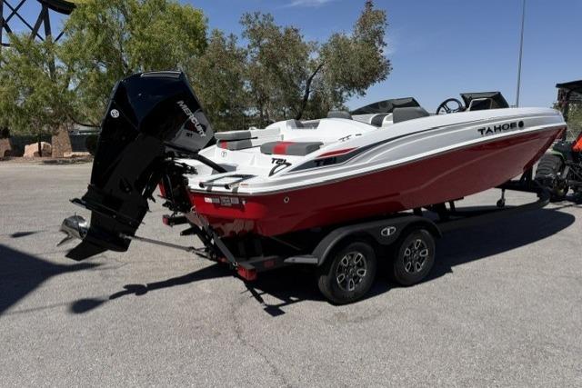 2026 Tahoe T21 boat on trailer, red and white design, parked outdoors.