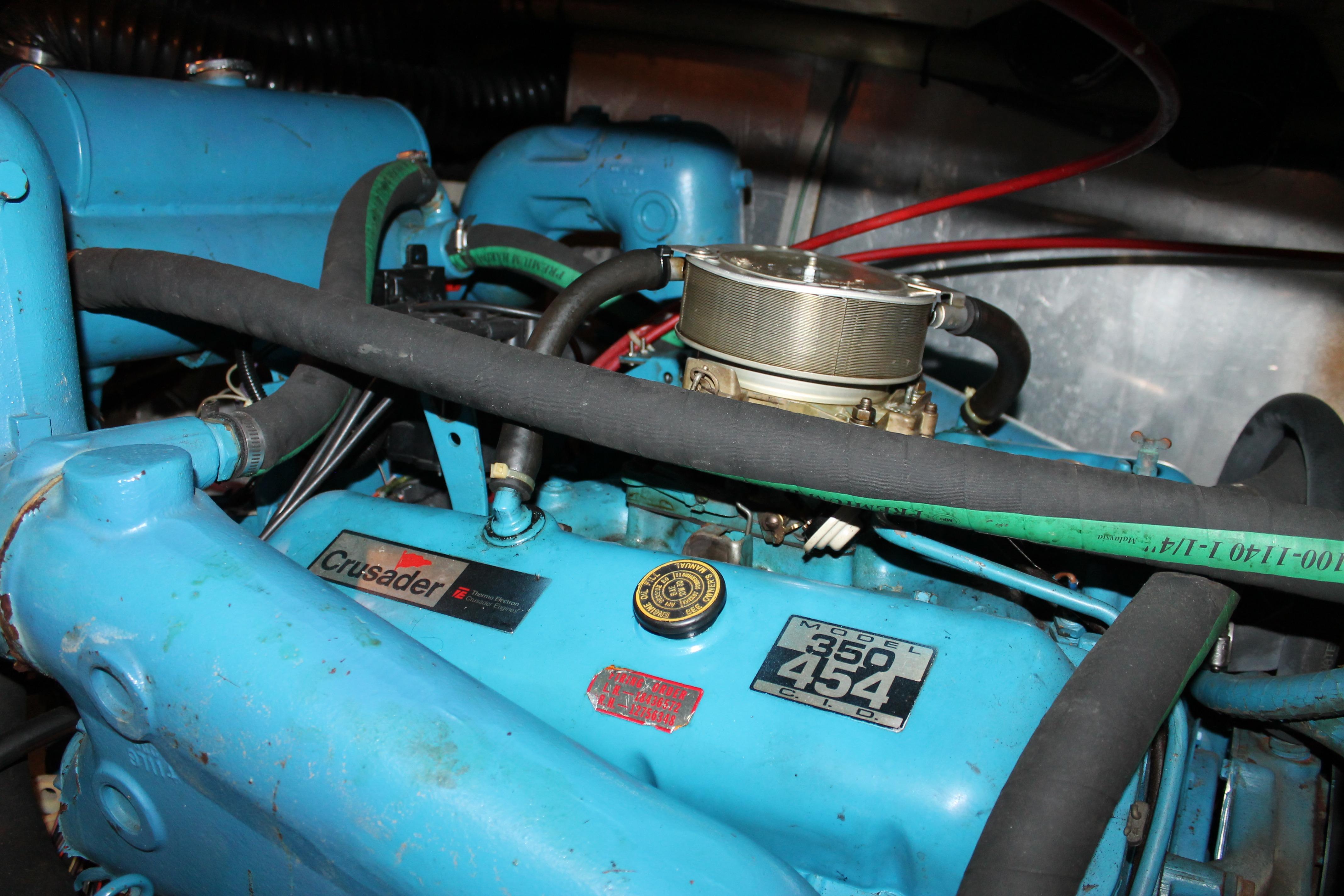 Engine of 1987 Chris-Craft 427 Catalina, featuring Crusader 350 model, blue components.